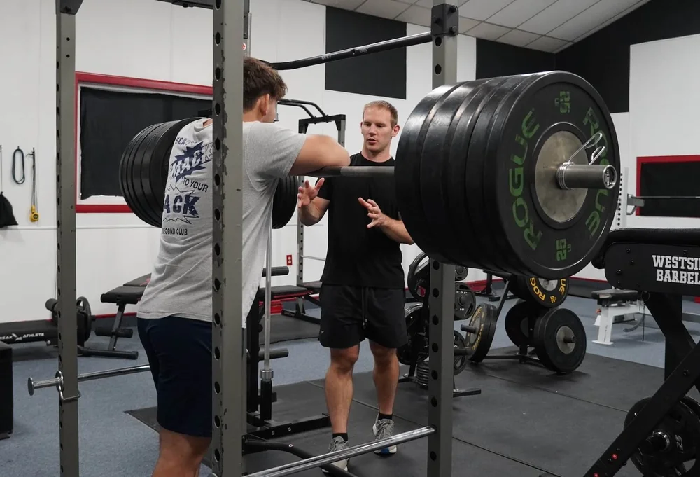 Coach Mike cueing an athlete under the bar