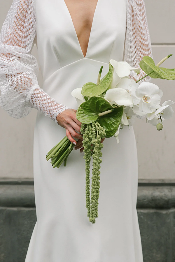 Detail shot of a bouquet. The bride is wearing a Long white dress from Marylise Bridal.