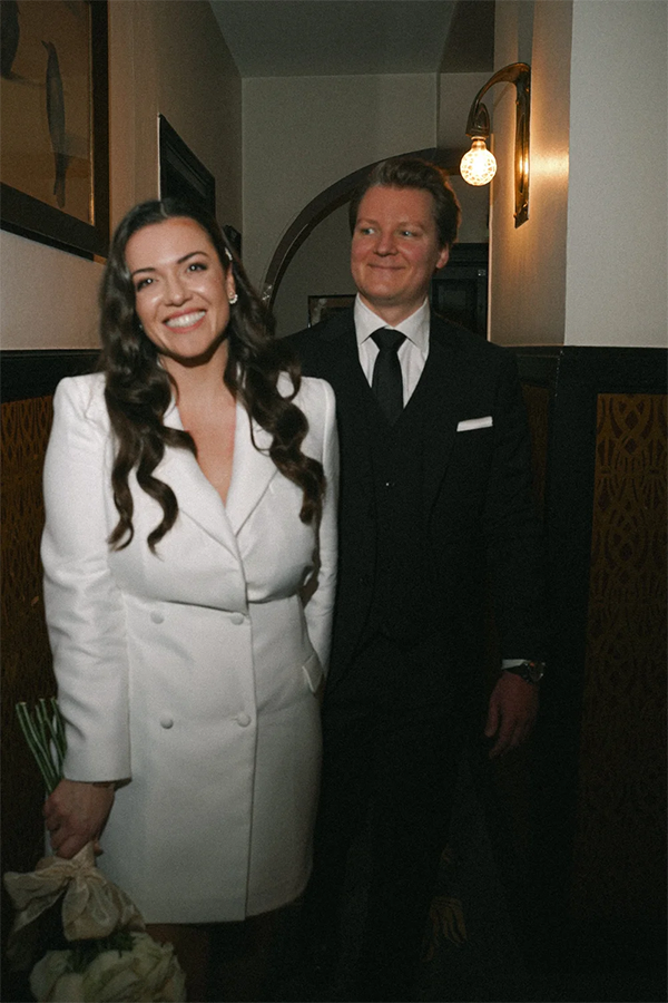 Couple on her civil wedding walking in a hotel.