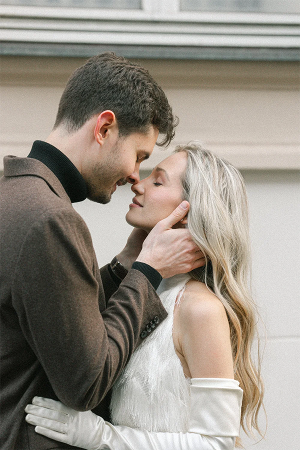 Bride and groom are kissing on the streets.