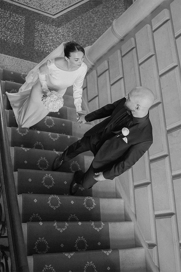 Wedding couple walking up the stairs at Schloss Lieser