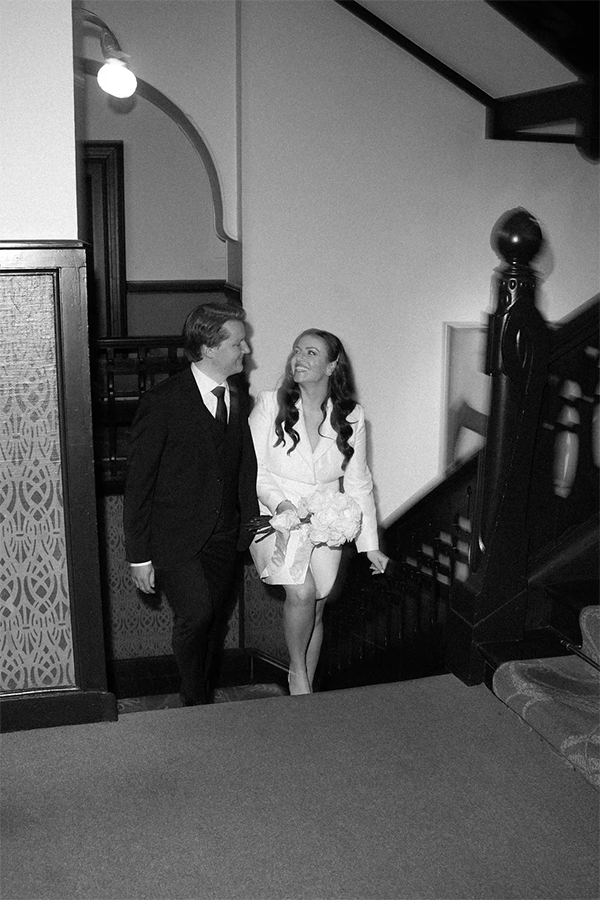 Couple on her civil wedding walking in a hotel.