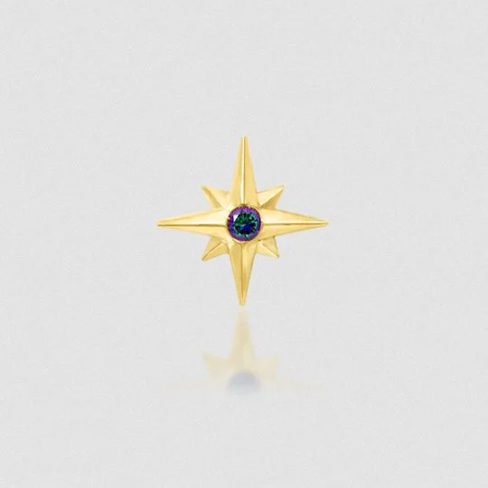 Gold star-shaped pin with a purple and green decorative center, placed on a white background.