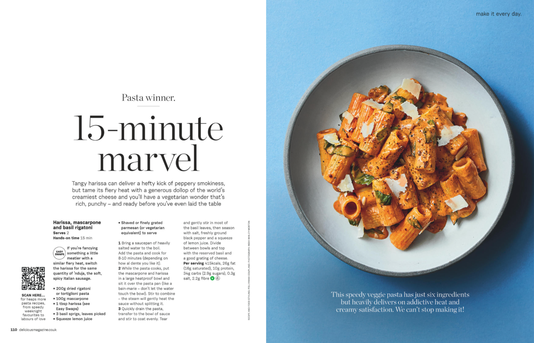 A plate of cooked pasta with sauce, garnished with cheese and herbs, placed on a blue background.