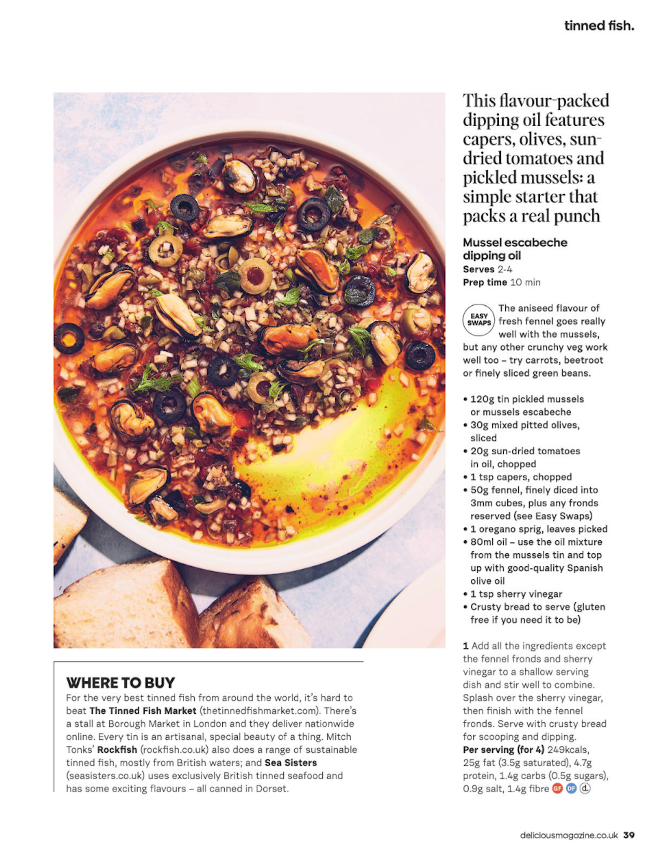 Bowl of mussel escabeche dipping oil with chopped tomatoes, olives, capers, and herbs, garnished with green herbs and drizzled with oil, surrounded by slices of bread.