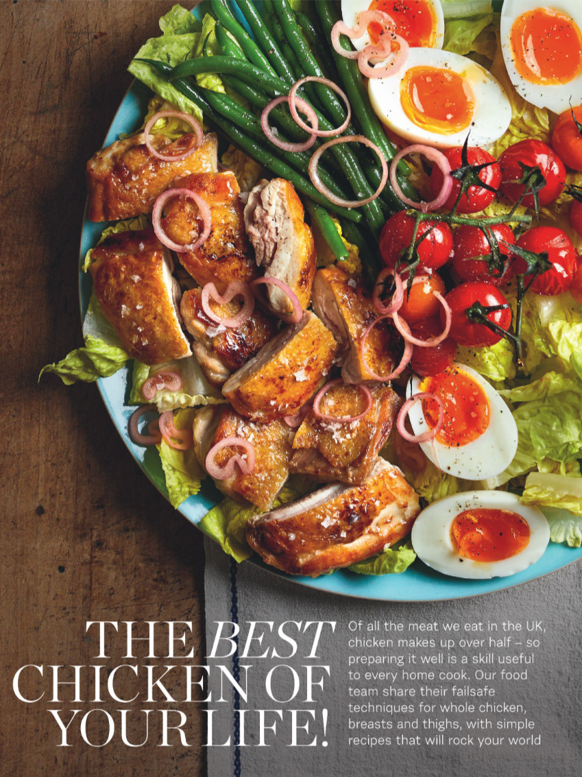 Platter of cooked chicken pieces, sliced boiled eggs, cherry tomatoes, green beans, lettuce, and pink onion rings.
