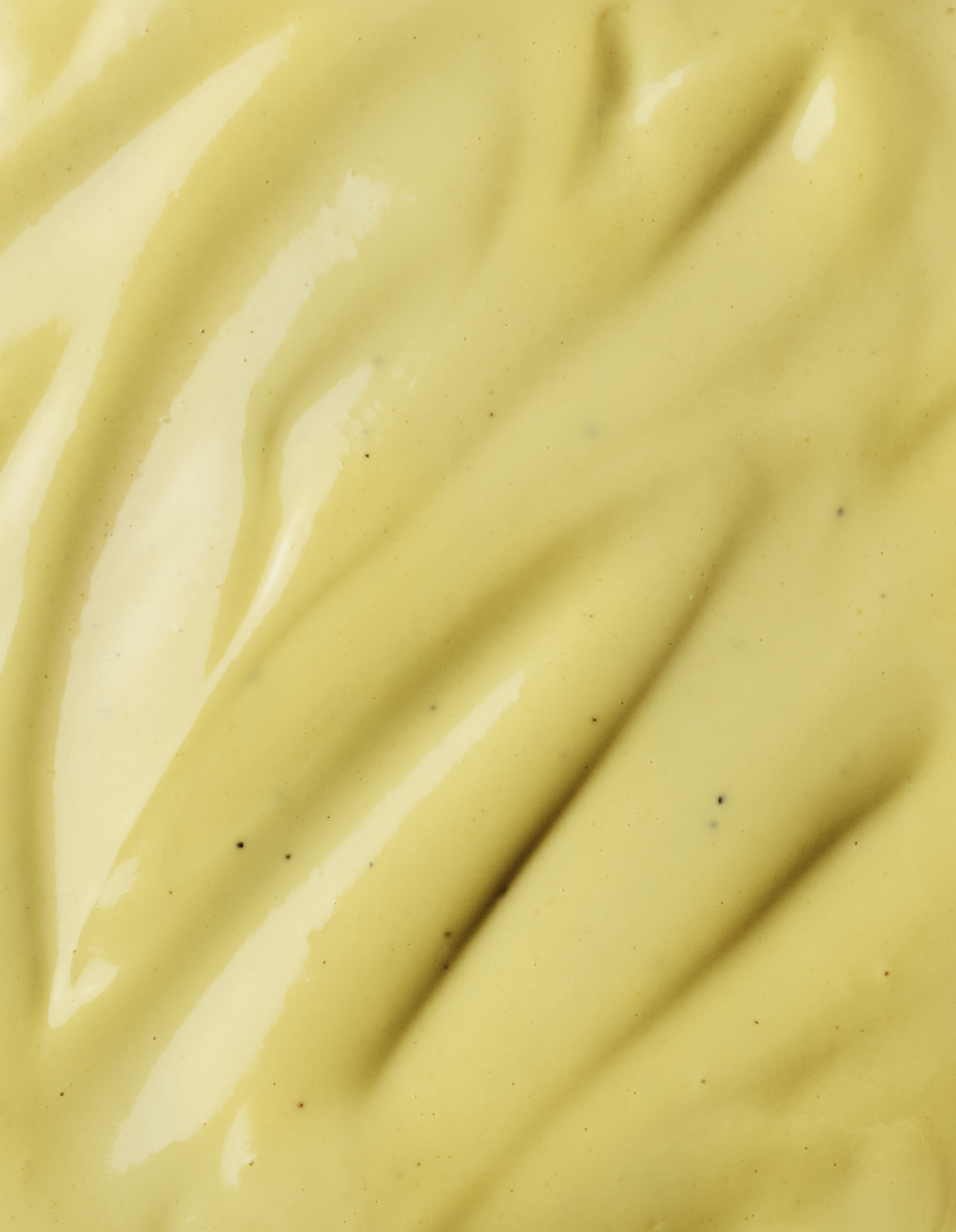 Close-up of yellow mustard sauce with diagonal lines.