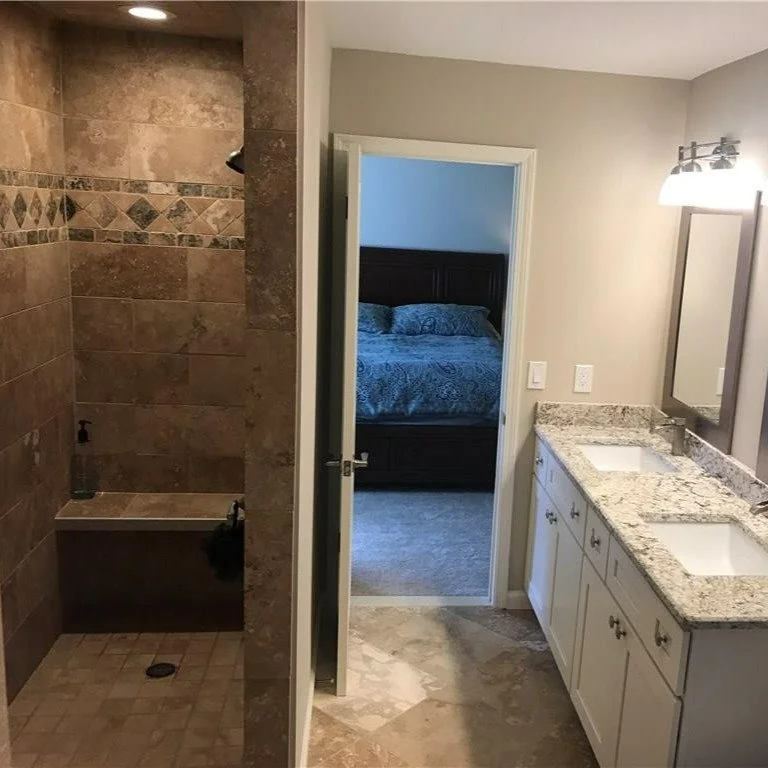 Before ➡️ After | Beige box to spa vibes.
We opened the shower, tiled it floor-to-ceiling with a statement band, added a built-in bench &amp; niche, new lighting, and a fresh double vanity with a granite top and framed mirrors. Clean, bright, and bui