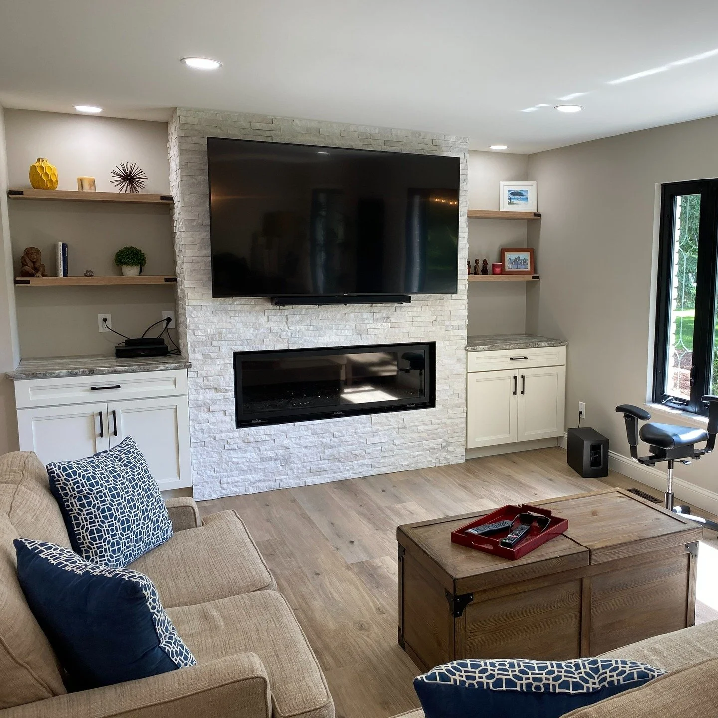 &bull; New framed chase for clearances &amp; wiring
&bull; Linear natural gas fireplace 
&bull; Stone veneer to the ceiling
&bull; Built-ins with slab tops + floating shelves
&bull; Fully concealed power/low-voltage for the TV
Weekend movie spot: act