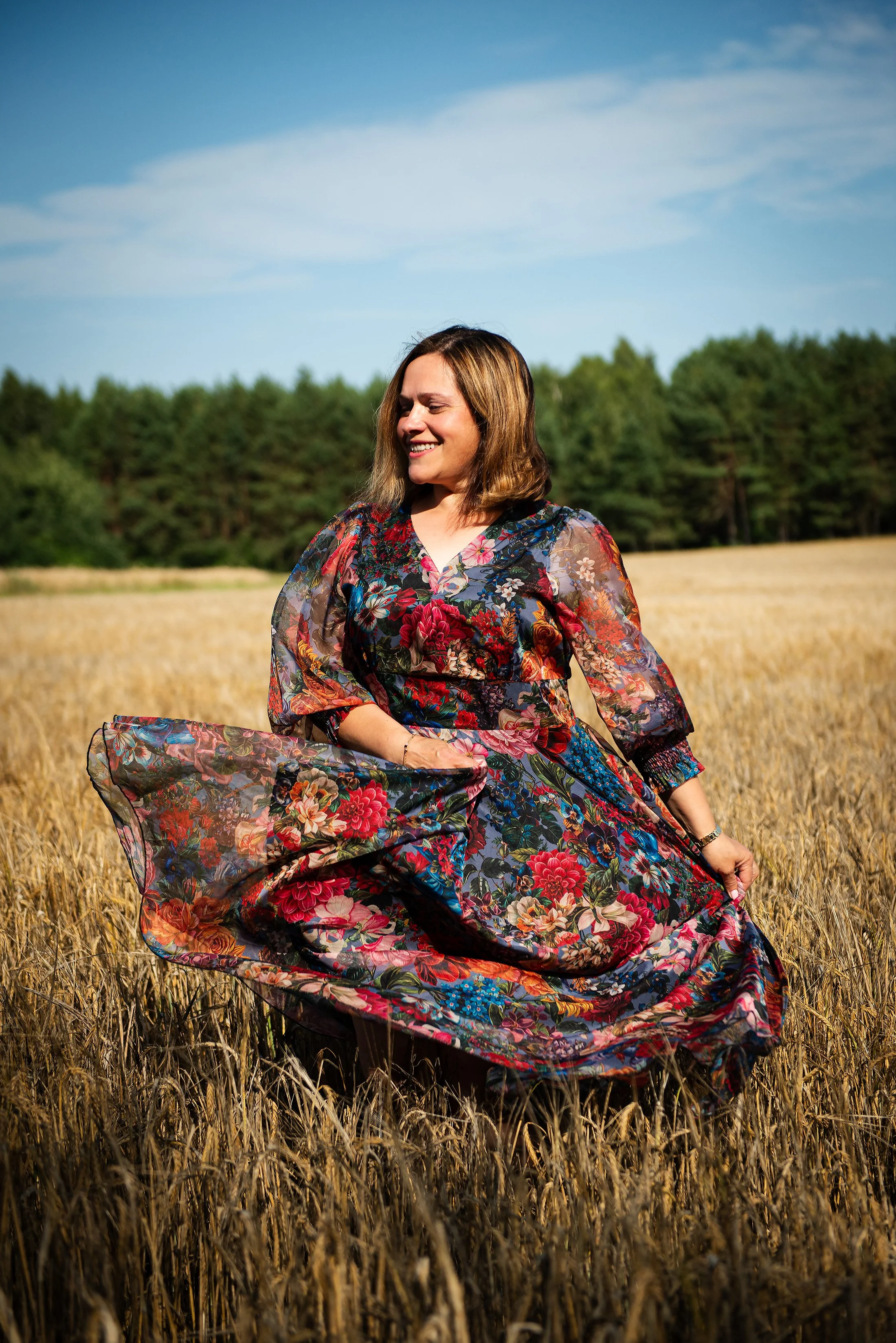 happy-woman-wearing-flowers-dress-dancing-grain-fiels-summer-time-golden-hour-photoshoot.jpg.jpg