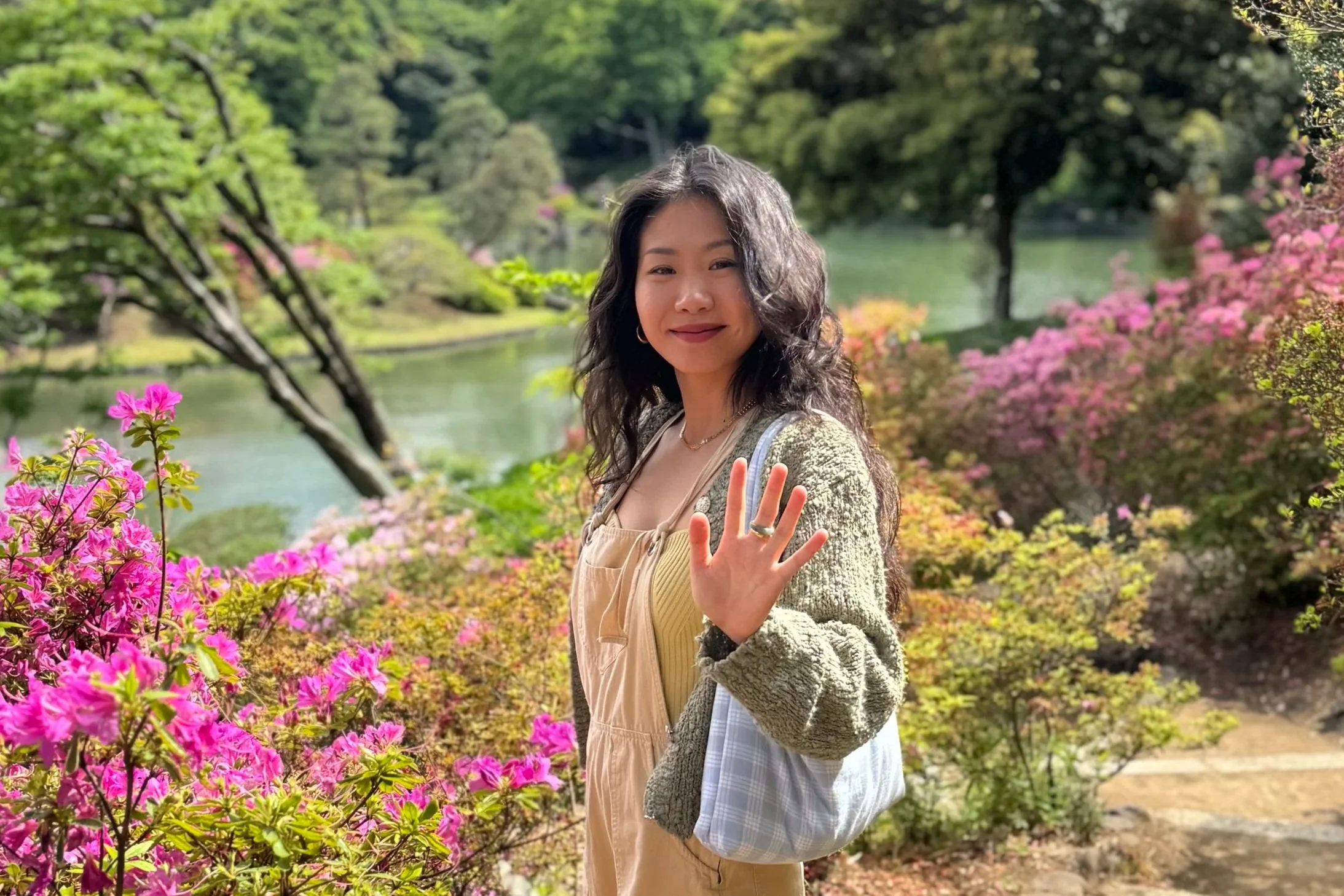 Angelina waving hello to camera in a garden