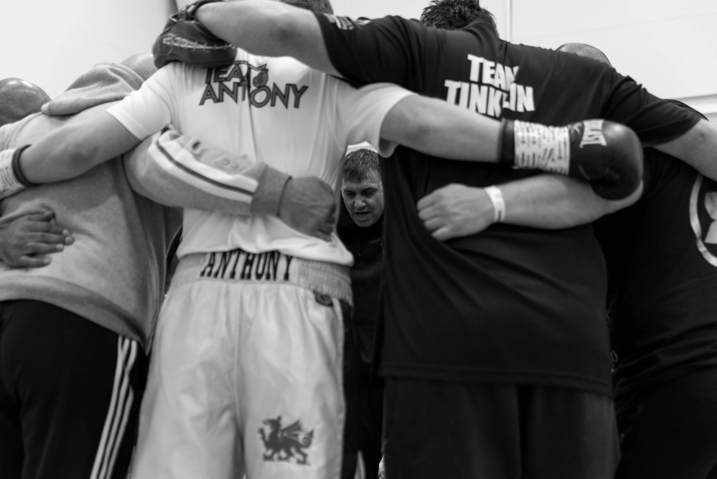 Chris Sanigar leads a prayer before all his fighters perform in Merthyr Leisure Centre