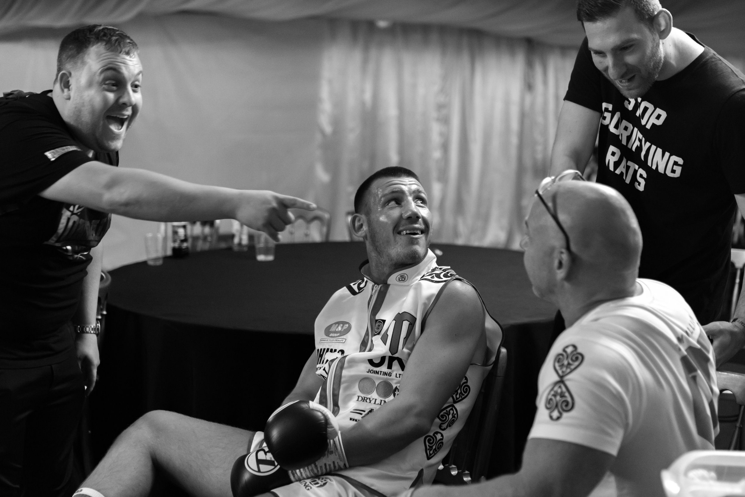Lee Eaton laughing at Domonic Ingle backstage whilst Liam Williams awaits his fight
