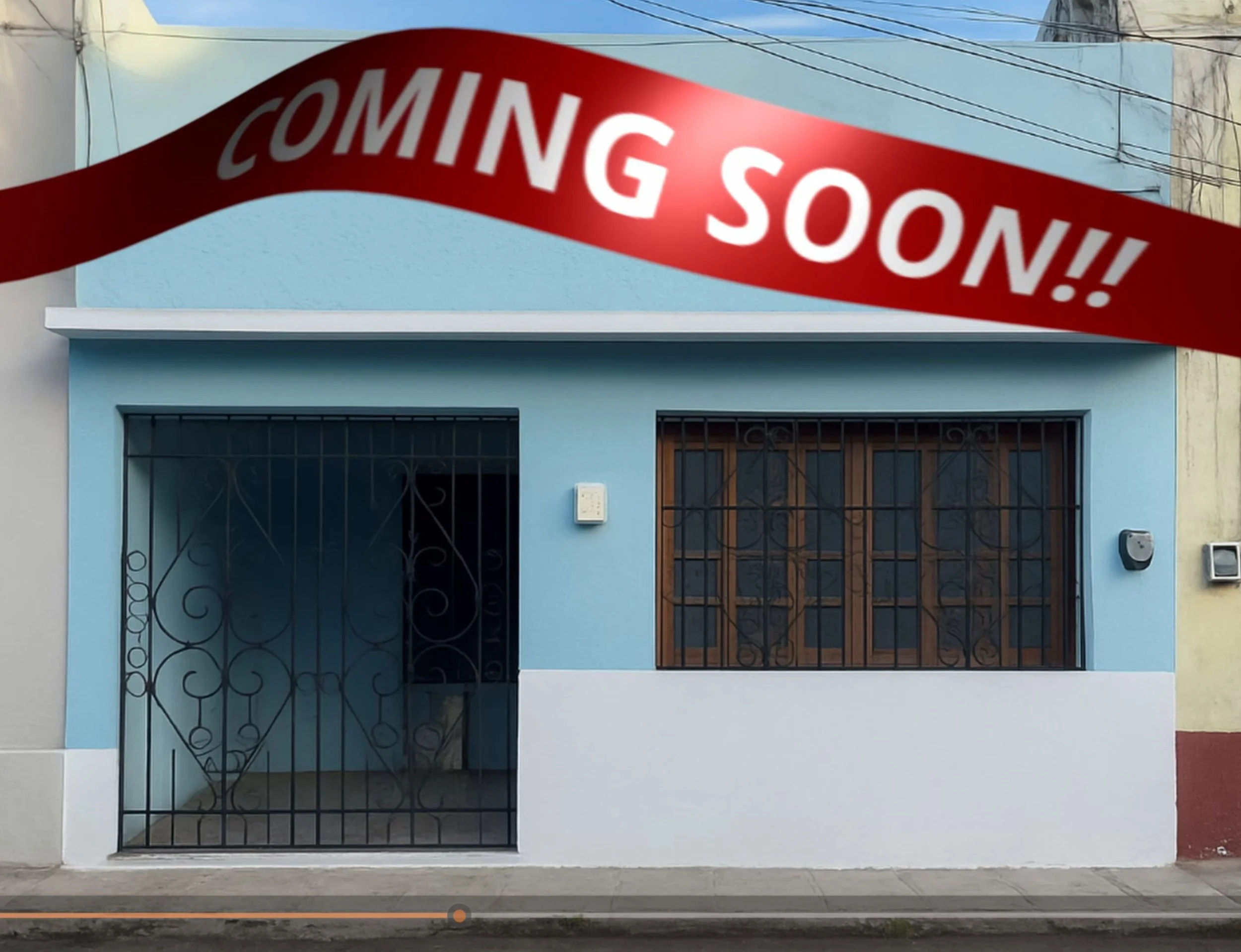A blue storefront with barred windows and door, with a red banner overhead saying 'Coming Soon!!'