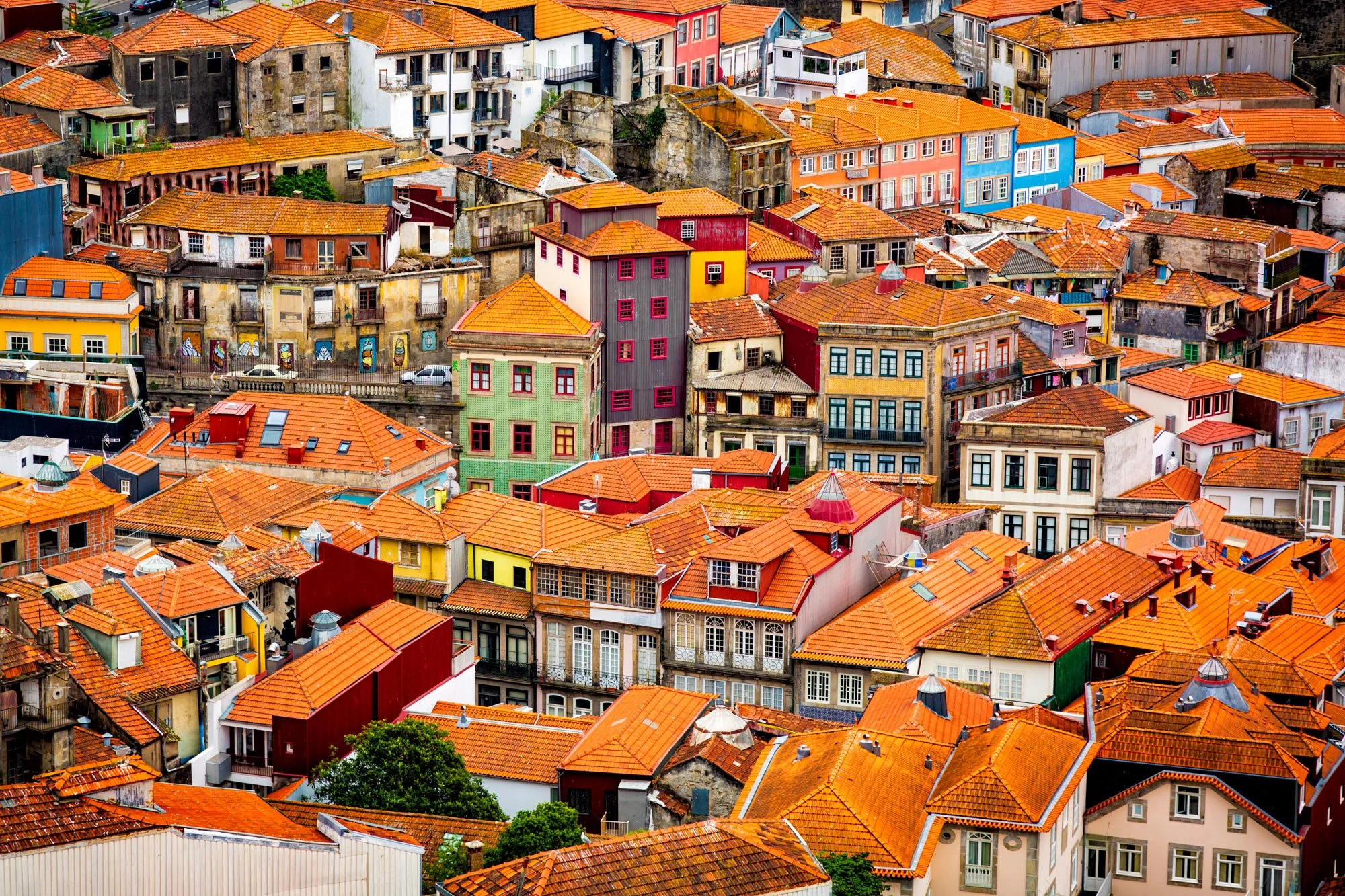 Fine art print photography for modern living room wall decor in Zürich.. Aerial view of colorful houses with orange tile roofs in a densely packed hillside neighborhood.