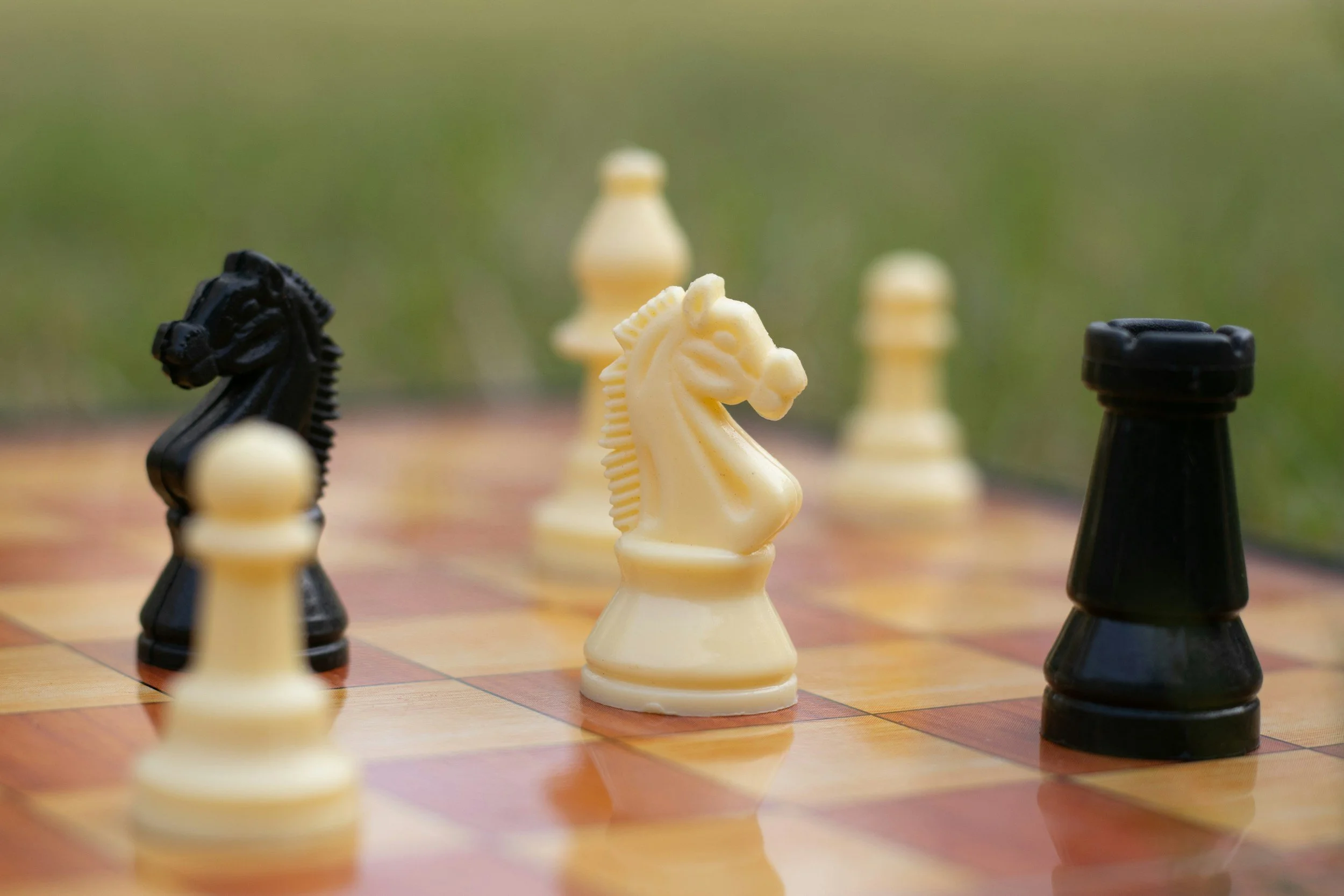 Chess pieces on a table in outdoor setting