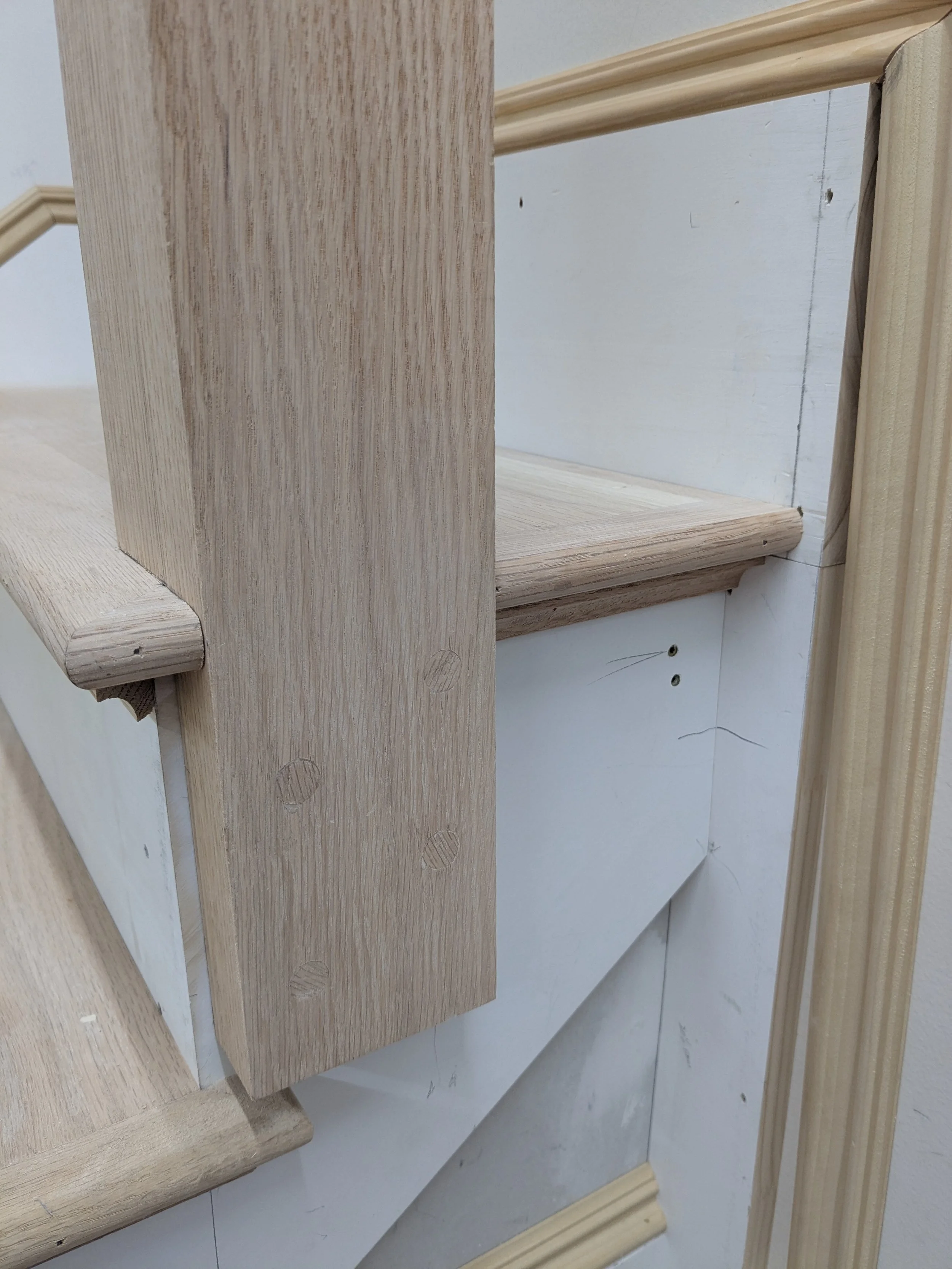 Newel post with matching plugs to hide bolts