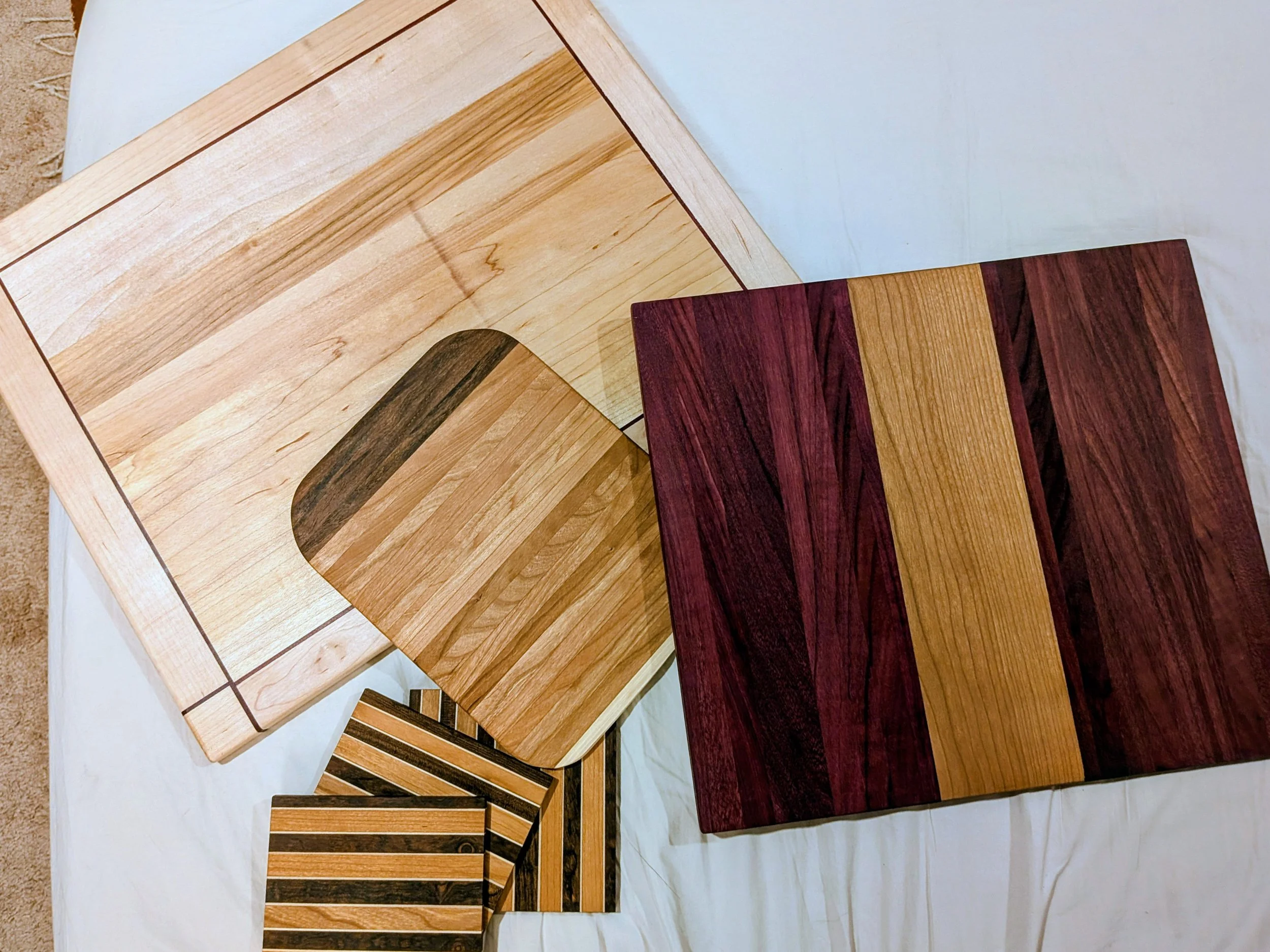 Cutting boards made of scraps of maple, purpleheart, sepele, and cherry
