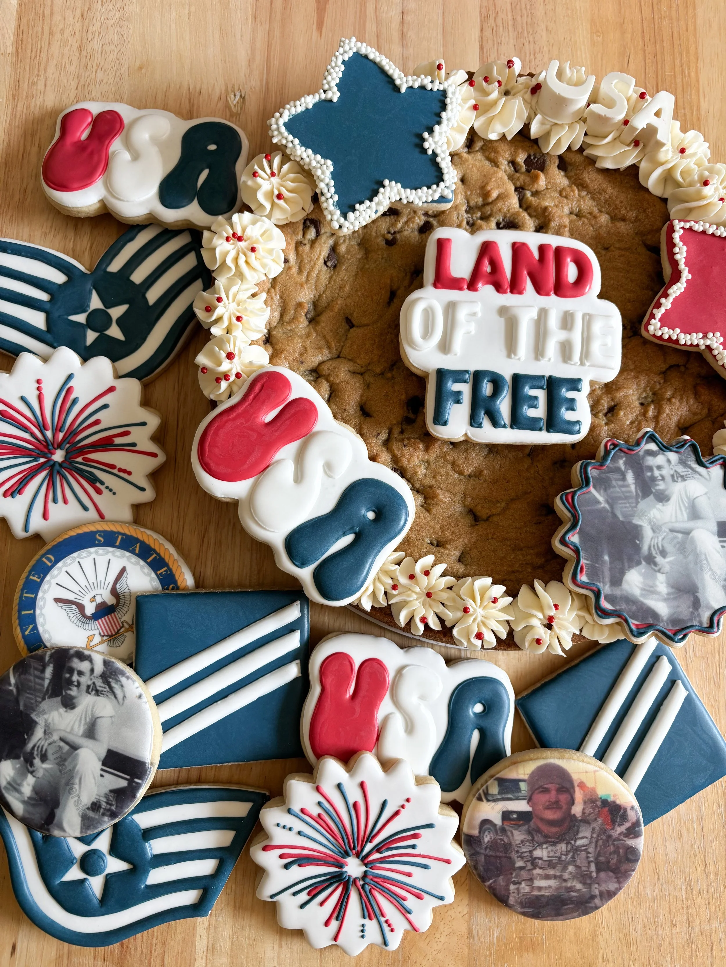 A decorated cookie wreath with patriotic-themed cookies and photos, featuring a central cookie with the words "Land of the Free."