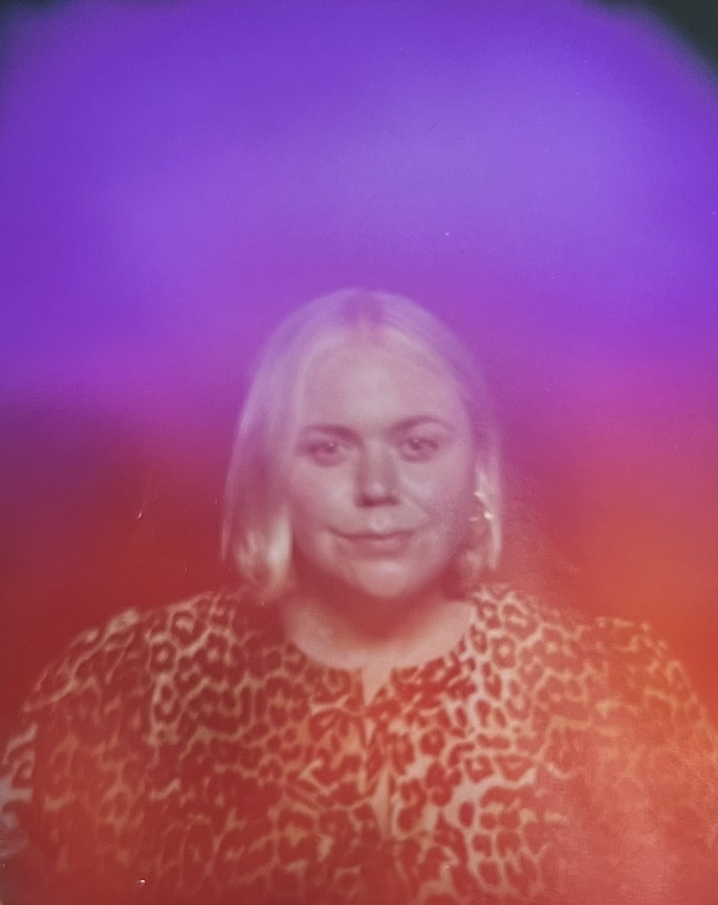 Photo of Sarah Wearing Leopard Shirt on a pink & purple background