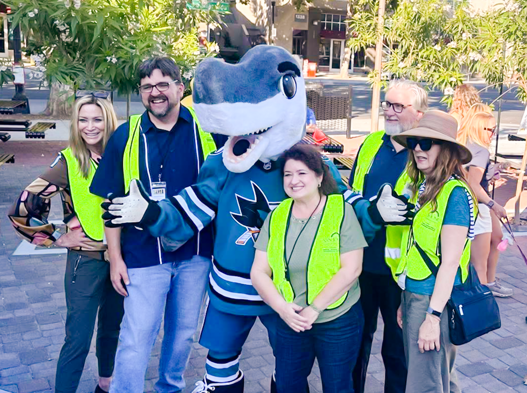 Photograph of the board members in the Beautiful Way Park with Sharkie.