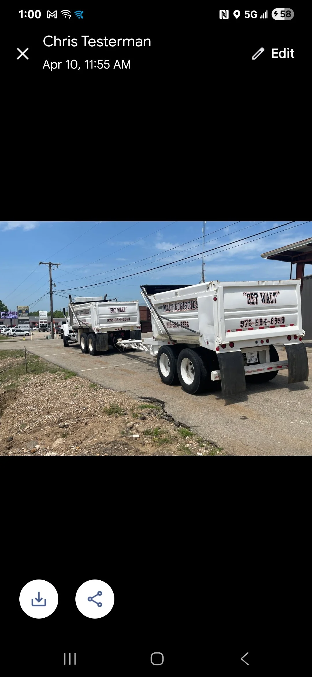 Two white dump trucks parked in a lot under a clear blue sky, with the name "Get Wact" and phone number printed on the sides.