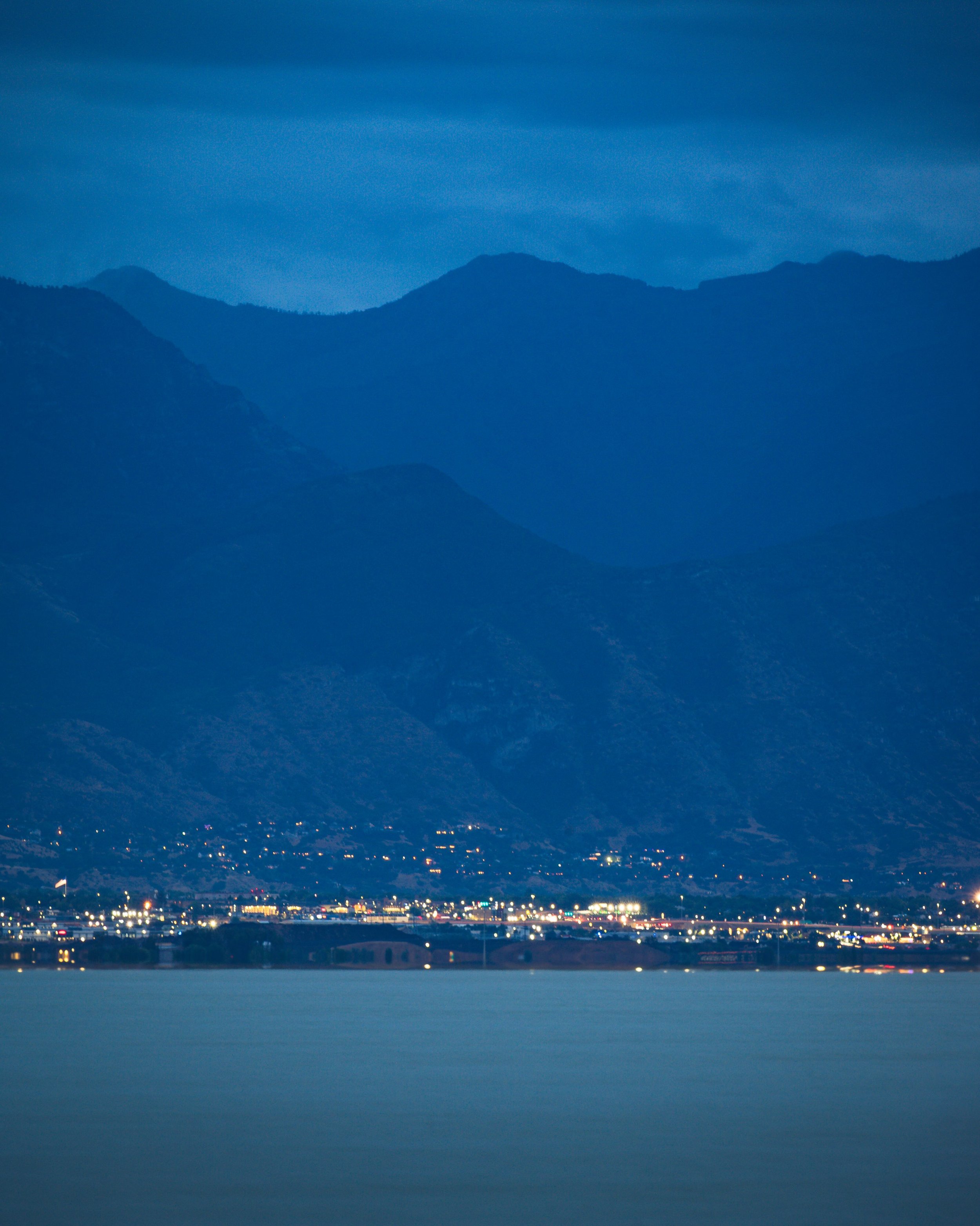 Wasatch mountains looming over city lights. Aug 13, 2026
