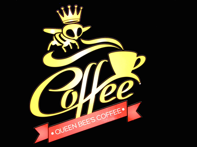 Logo featuring a stylized skull with a crown, the word 'Coffee' in script, and a red banner with 'Queen Bee's Coffee'
