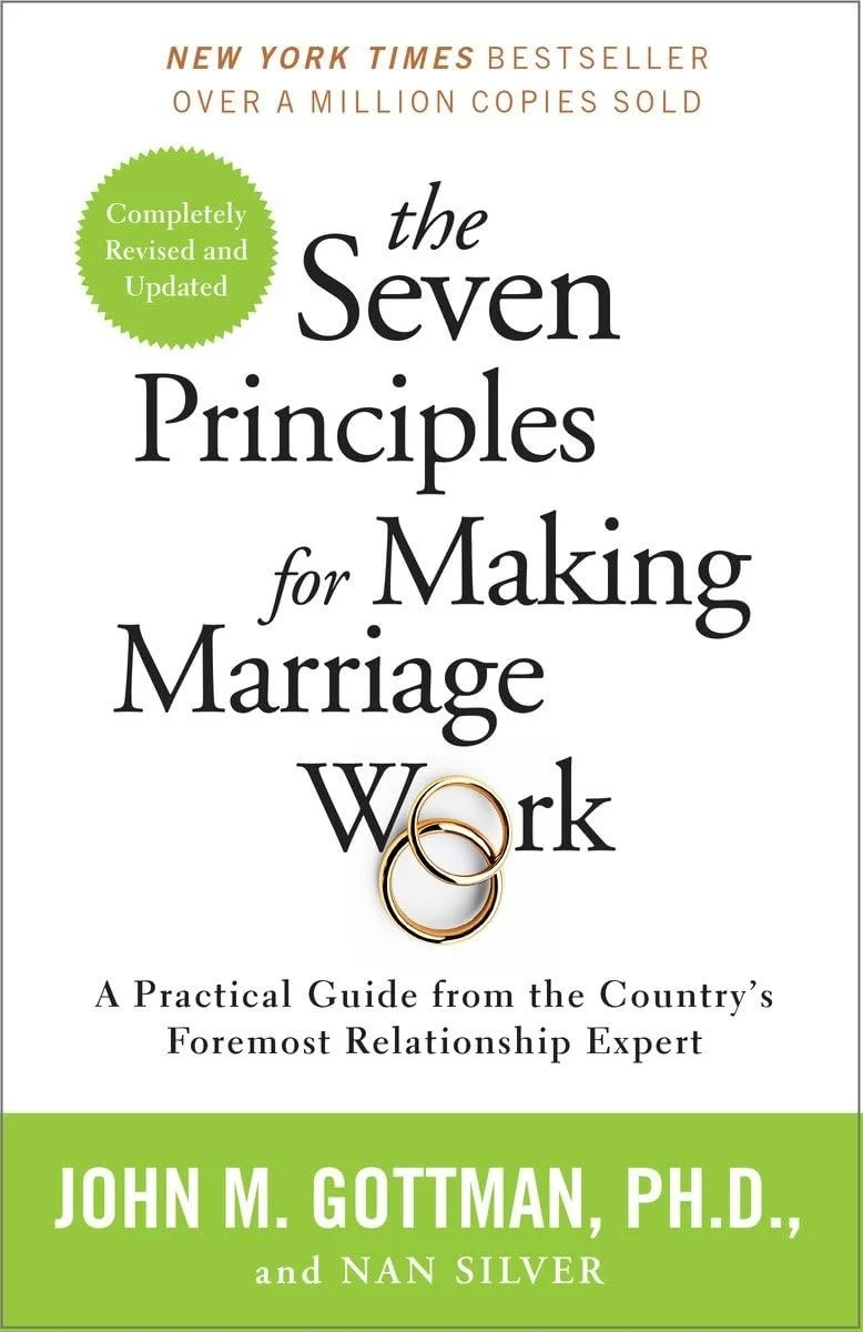 Cover of a book titled "The Seven Principles for Making Marriage Work" by John M. Gottman, Ph.D., and Nan Silver. The cover features two wedding rings intertwined and a green circular badge indicating "Completely Revised and Updated."