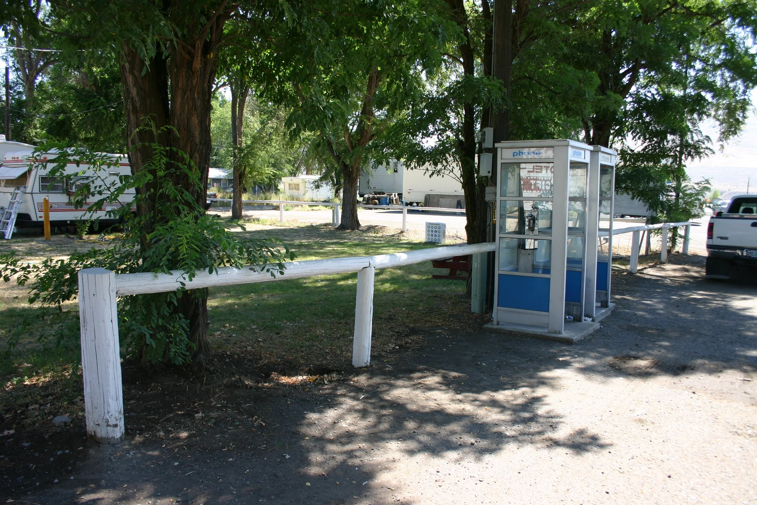When we passed through in 2005, not much had changed. The pay phones were still there, along with the white railing and the patch of grass beyond where we pitched our tent. (Click image for geotag)