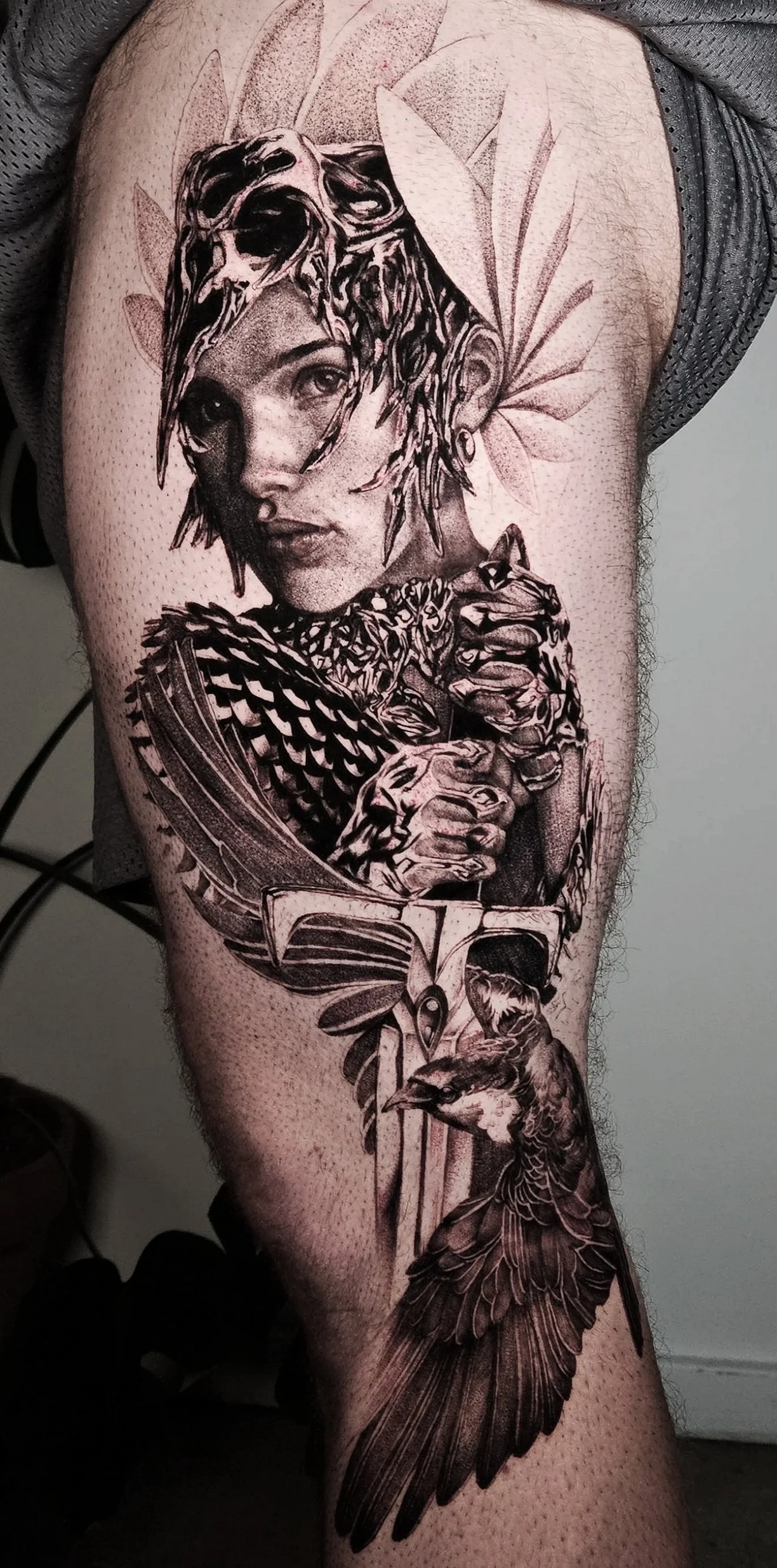 celtic goddess black and grey realism/surrealism stipple shading tattoo large scale thigh peice leg panel tattoos that create a fine art bespoke collectable quality with chrome details beautiful portrait bird feathers sword armor knight warrior silve