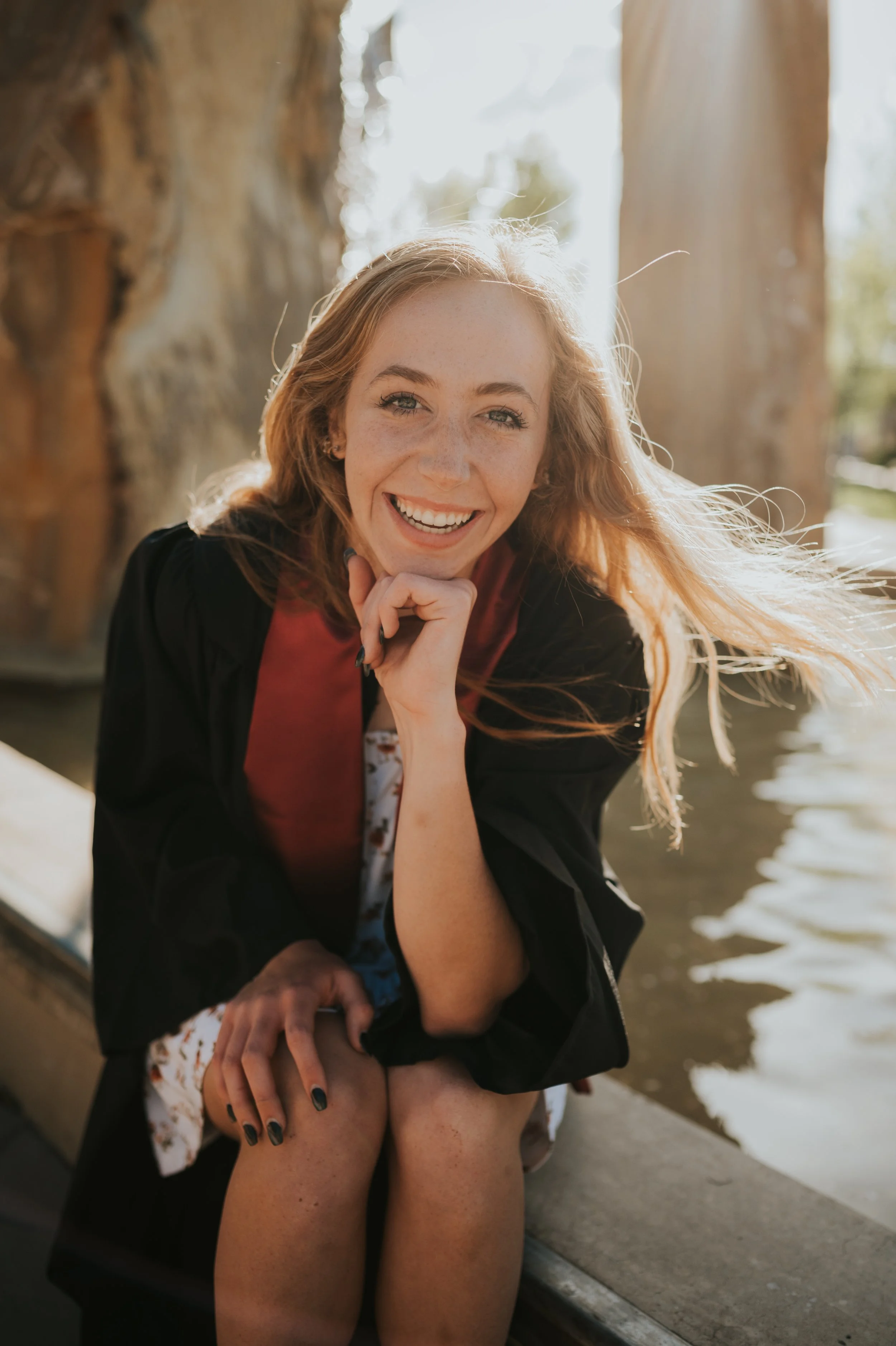 girl in grad regalia smiling at camera