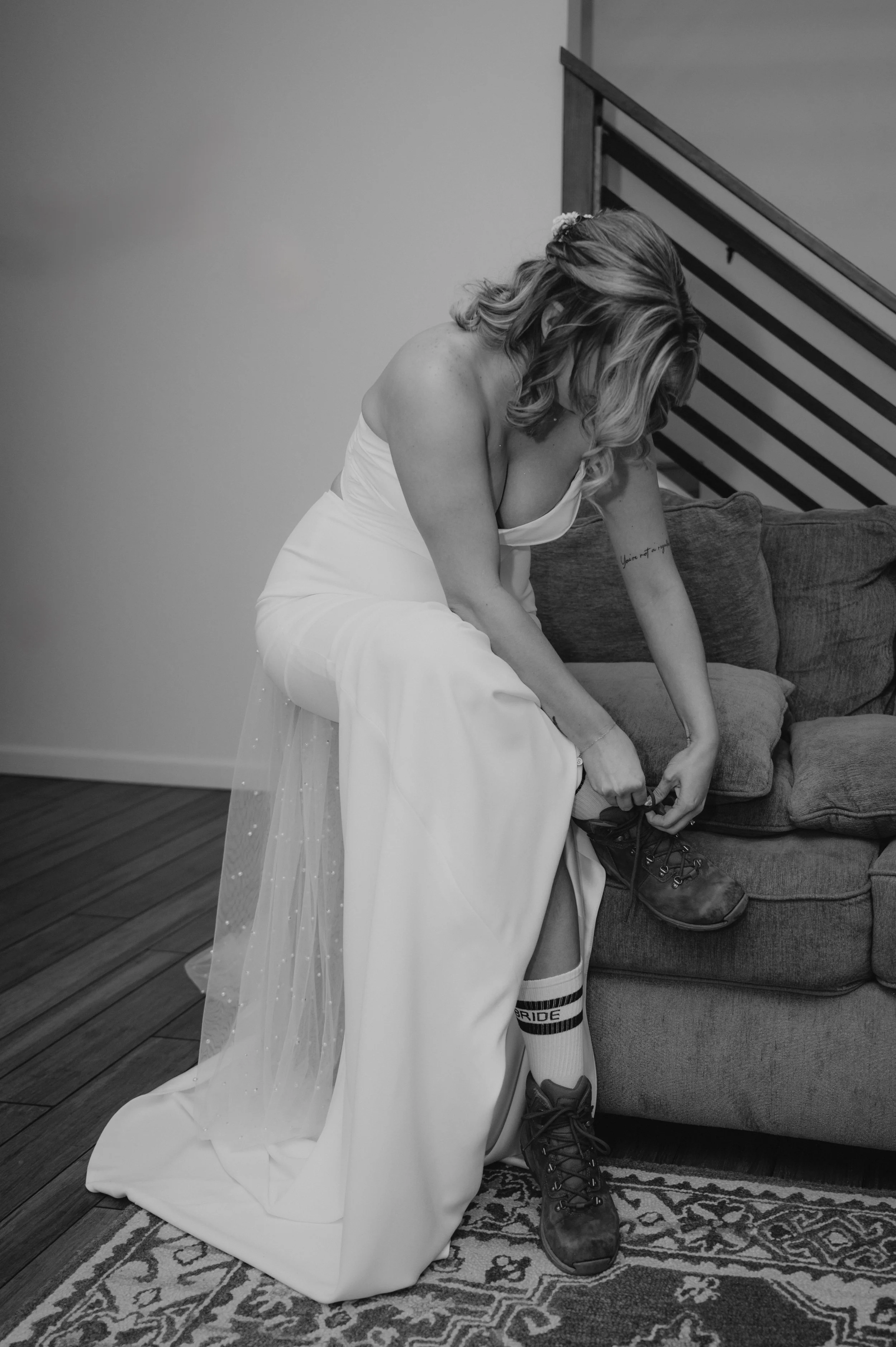 bride putting on hiking shoes