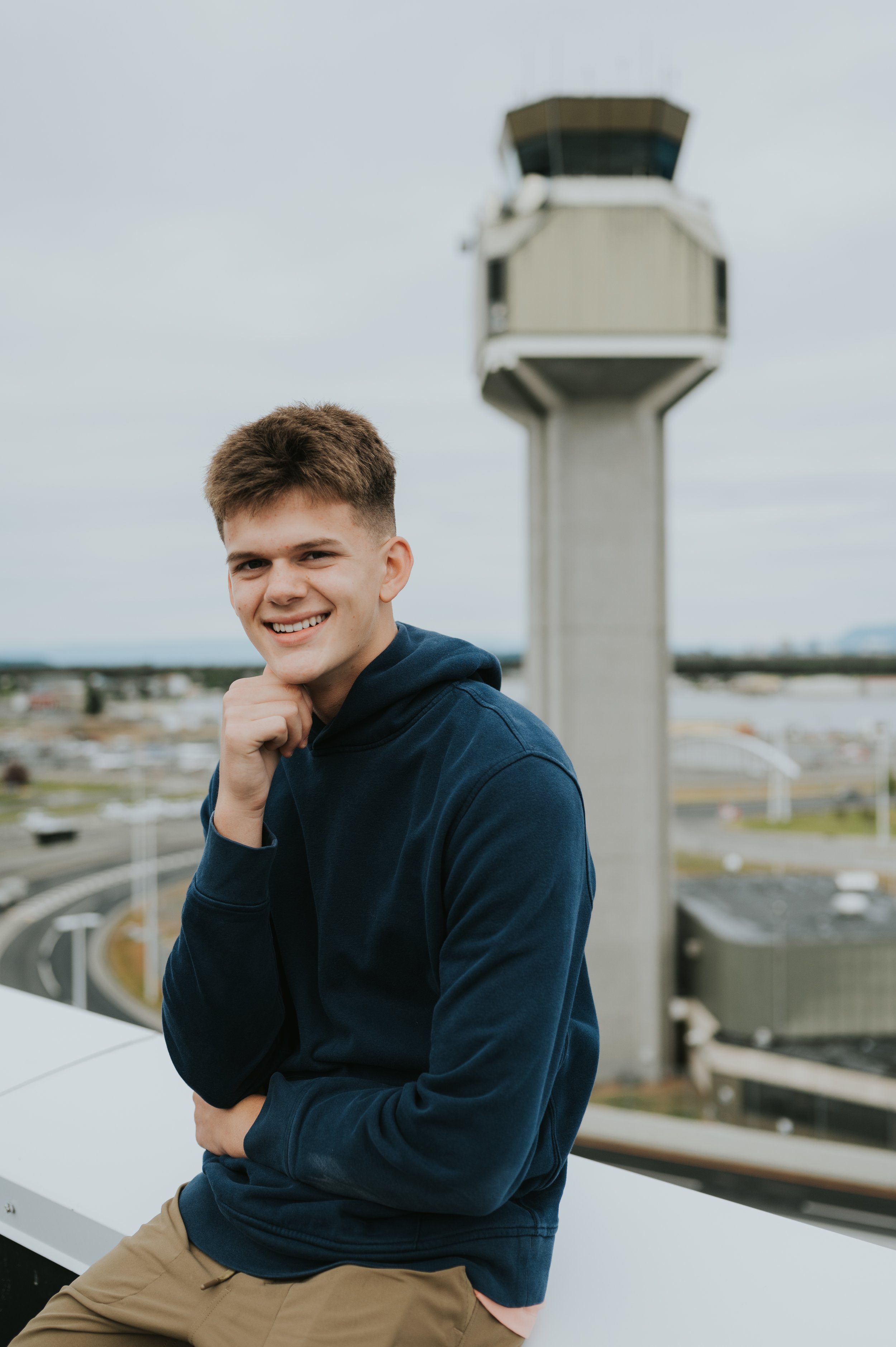 boy in front of air traffic tower smiling