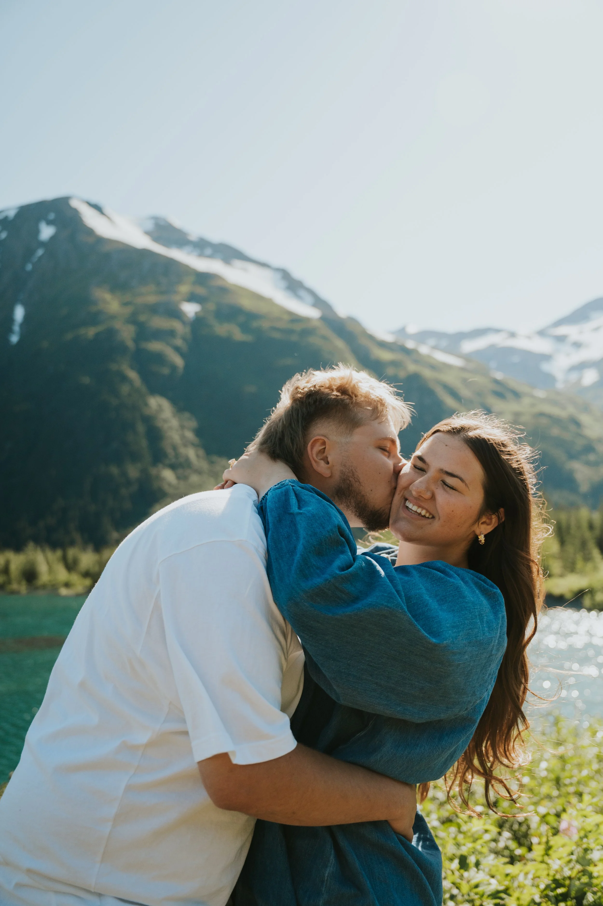 engaged couple in sun smiling
