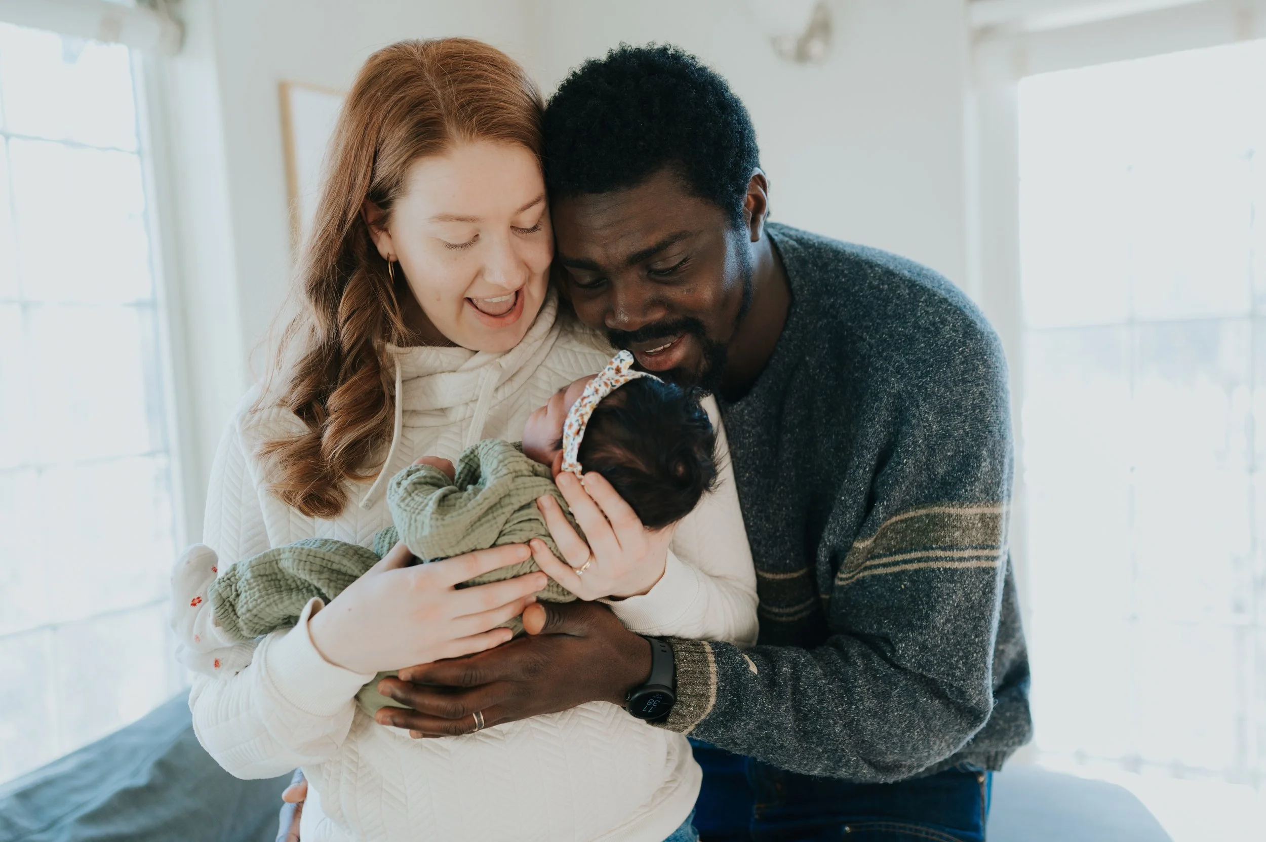 mom and dad holding newborn baby