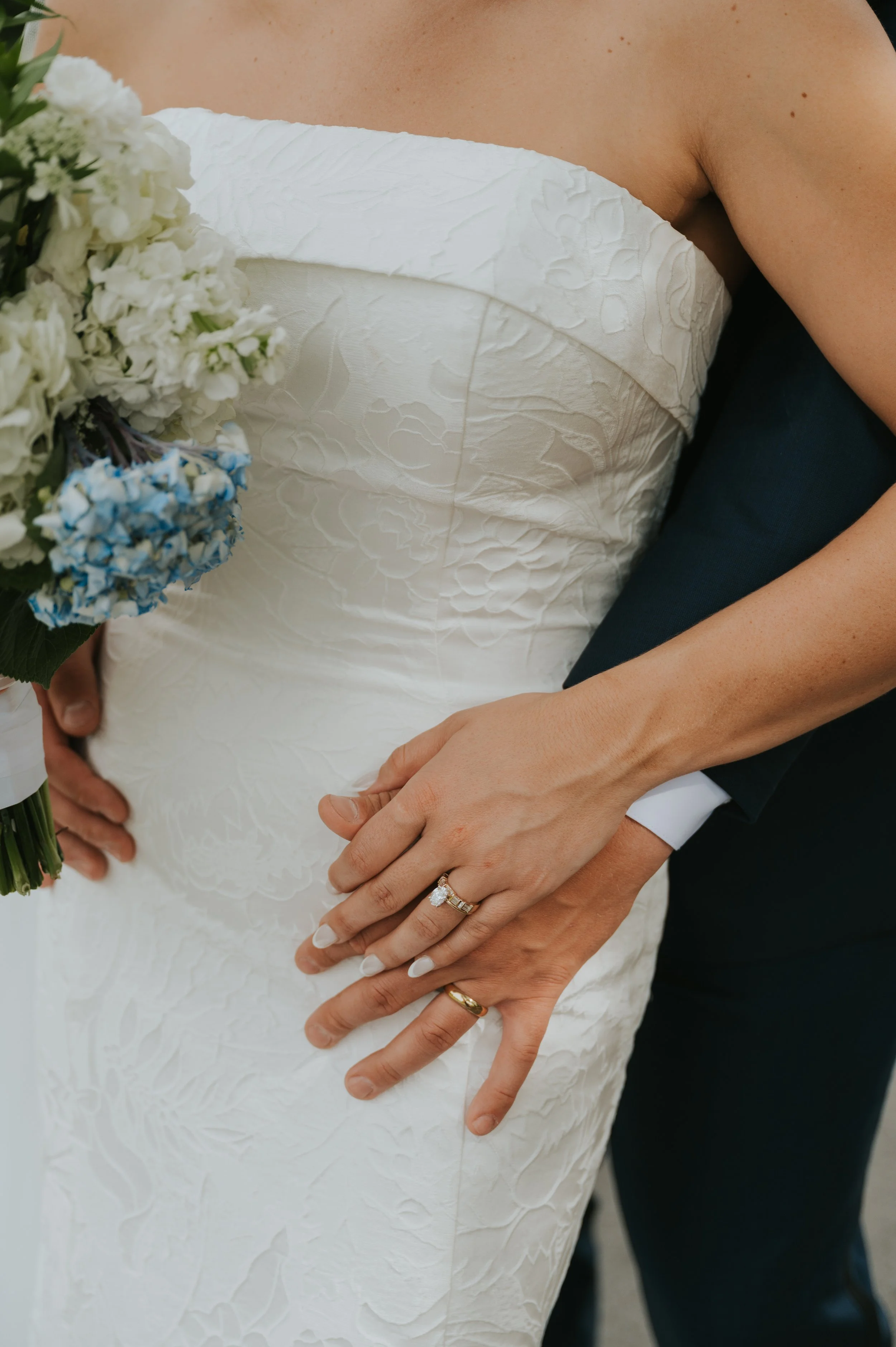 wedding closeup of wedding rings on dress