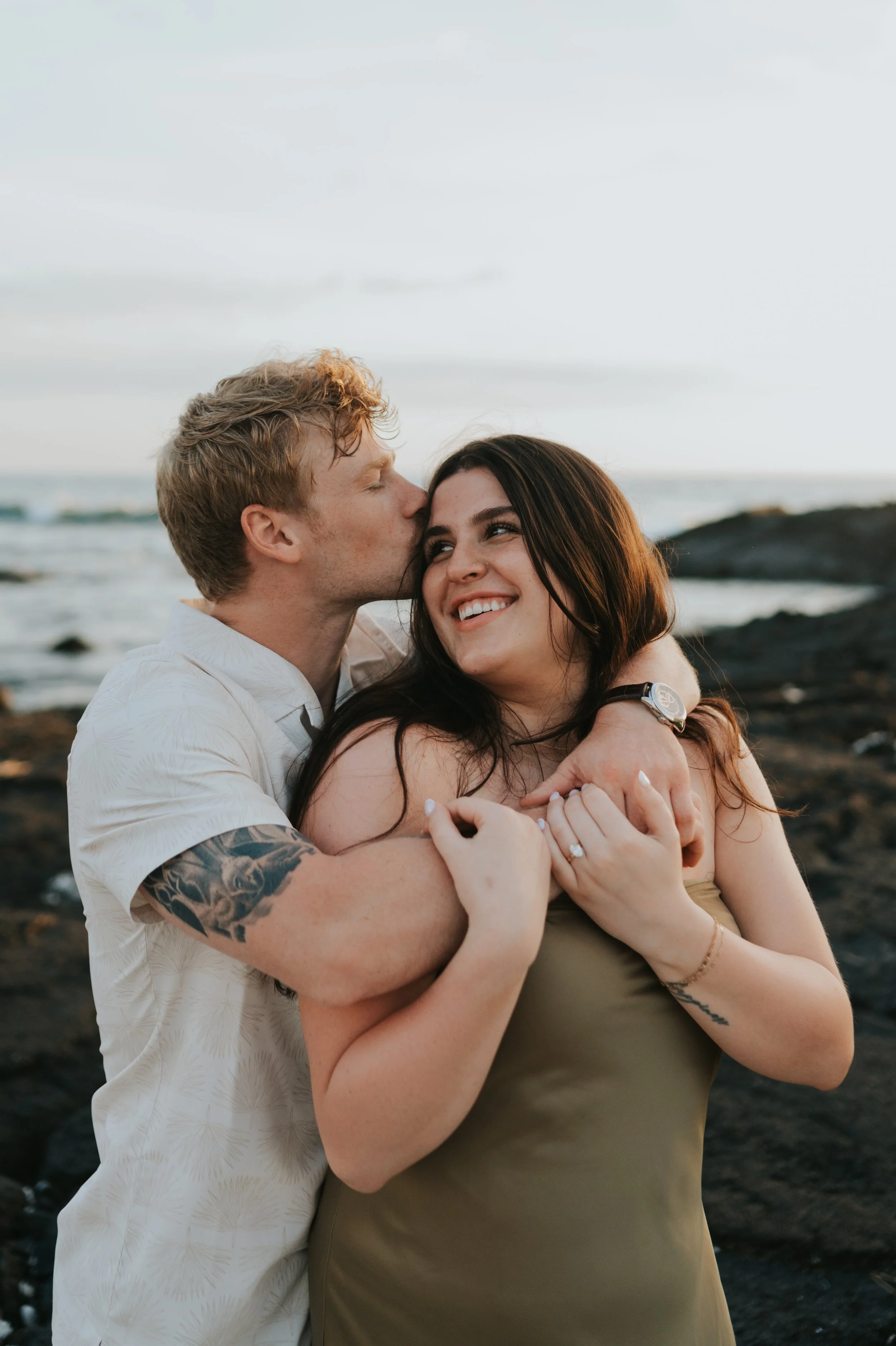 engaged couple in sun smiling