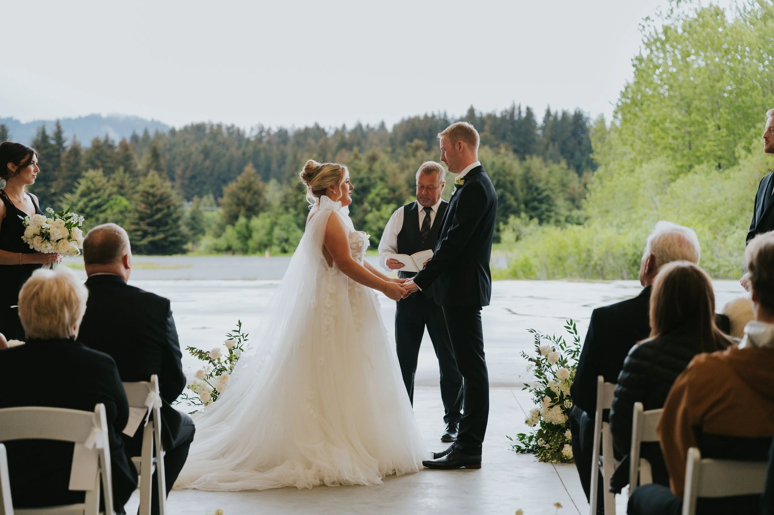 bride and groom holding hands during wedding ceremony