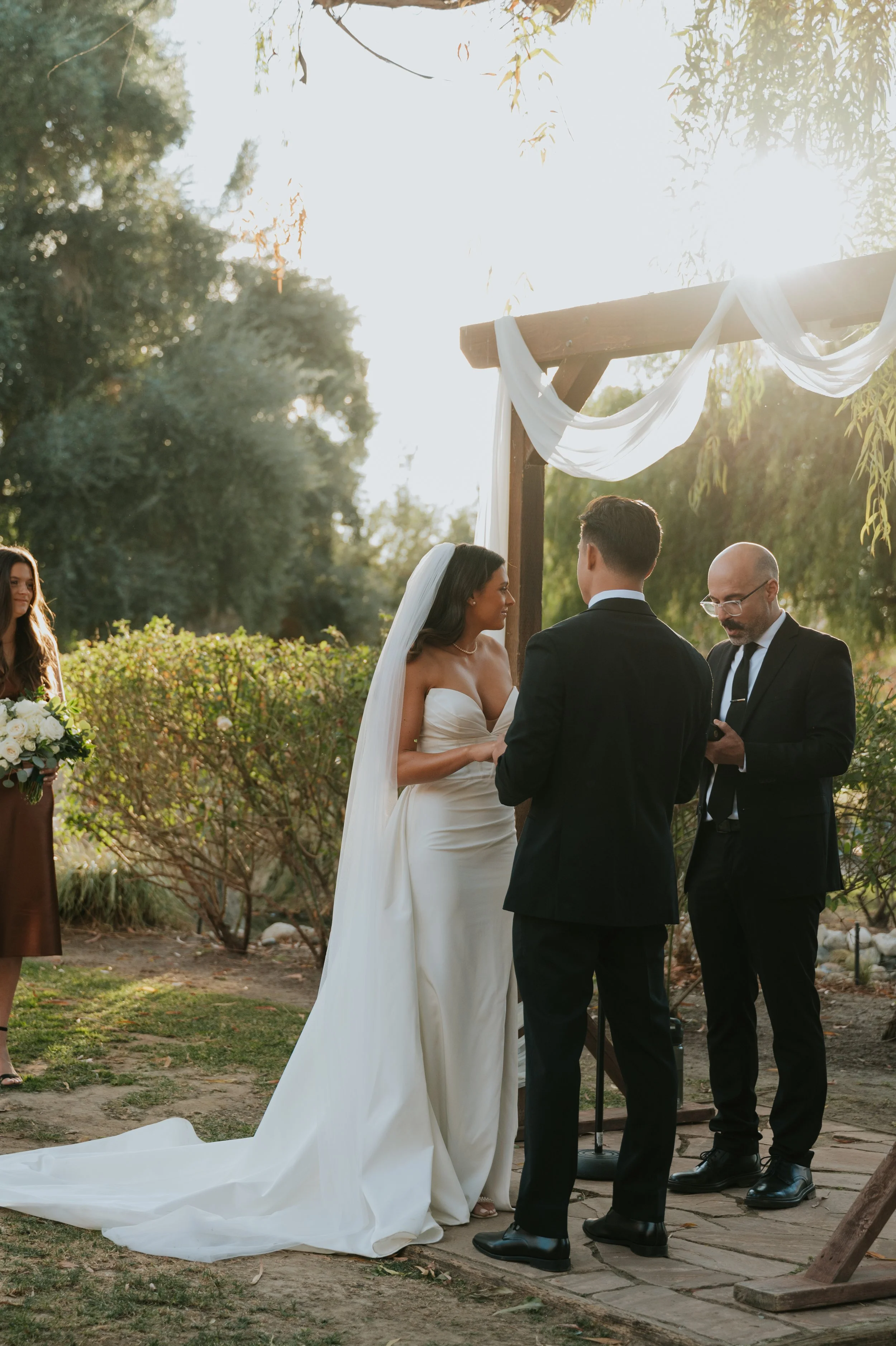 bride and groom under altar