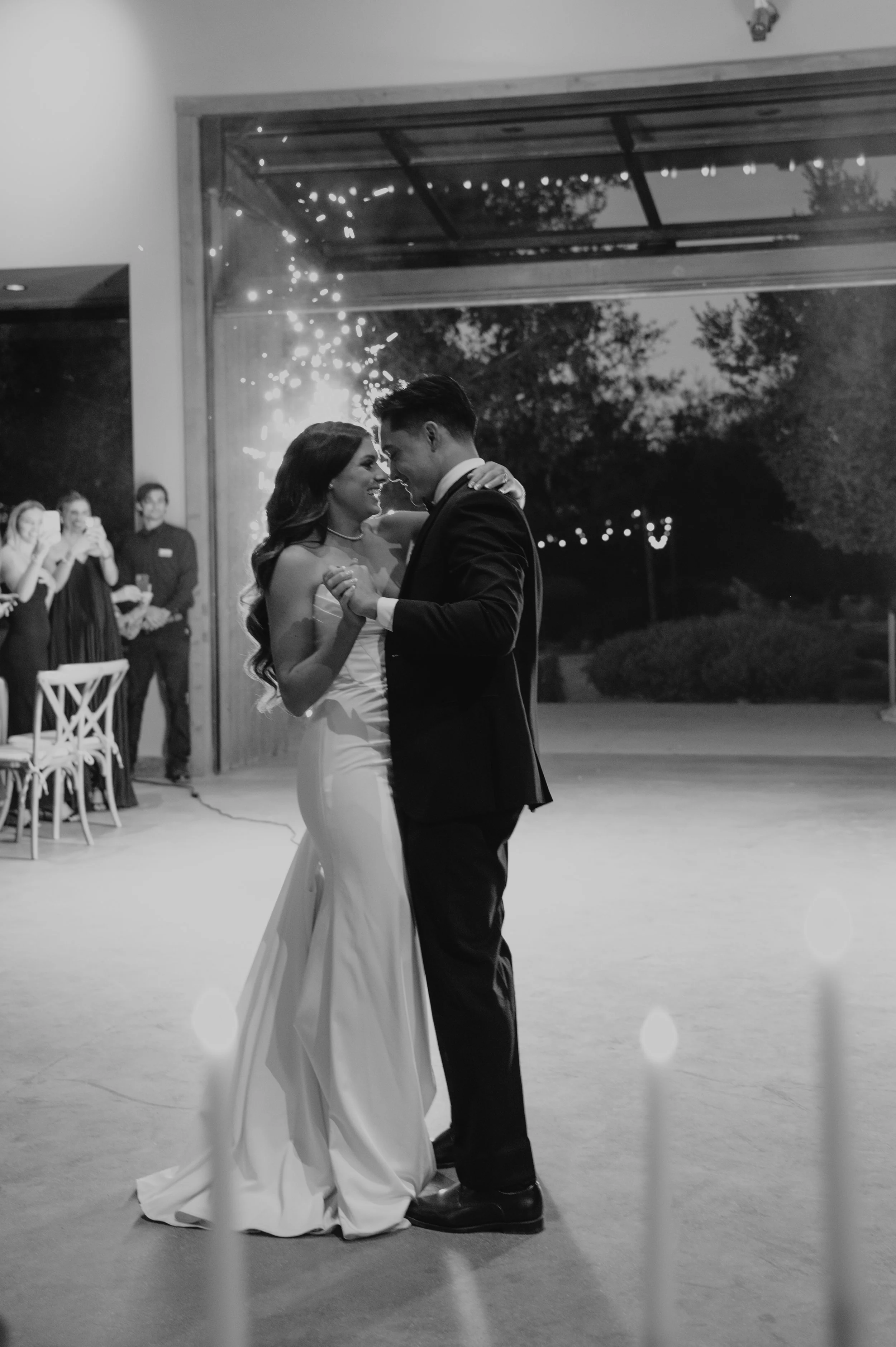 bride and groom dancing in front of sparklers