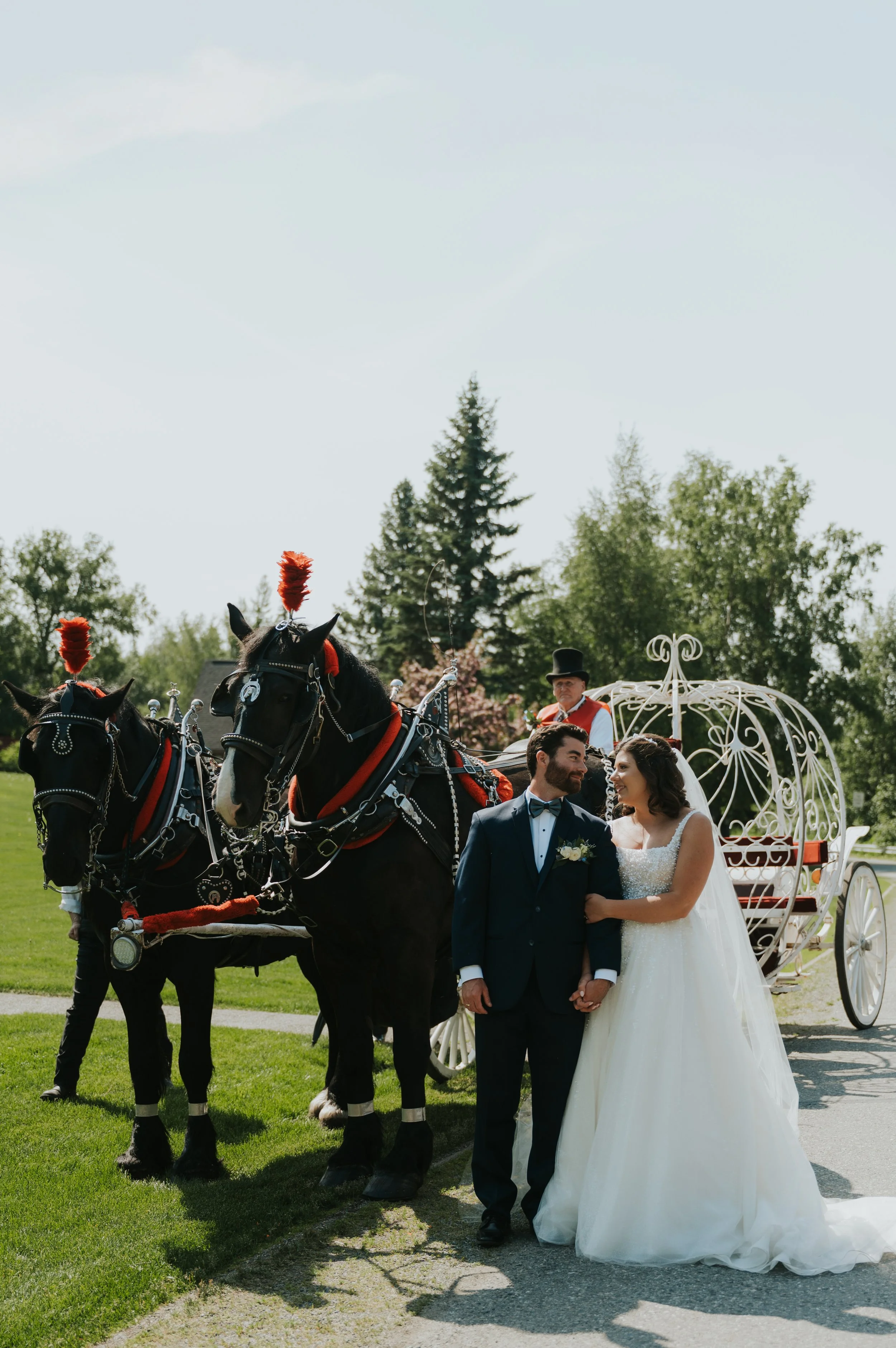 bride and groom in front of horse carriage
