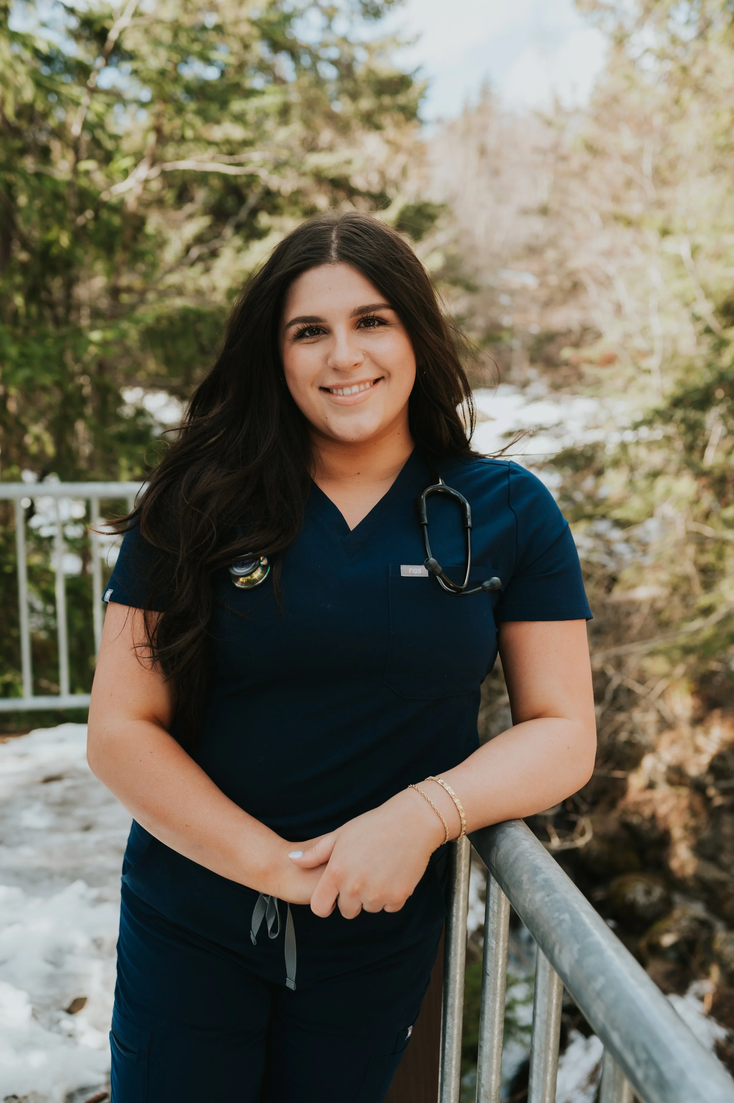 girl in scrubs outside smiling