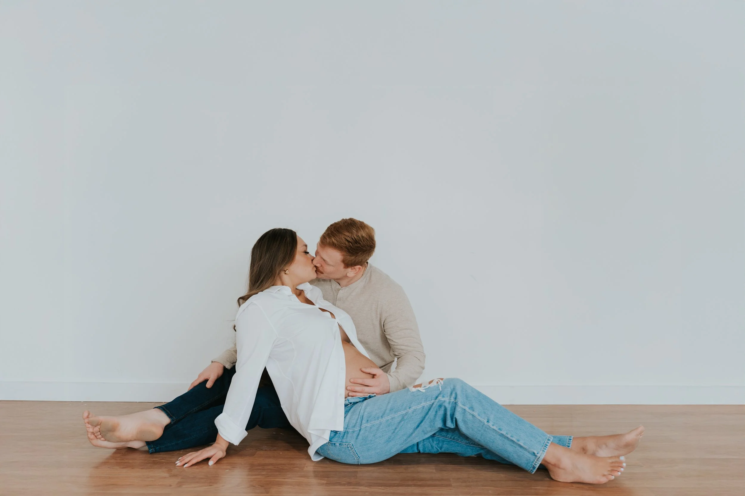 couple in white studio maternity photos