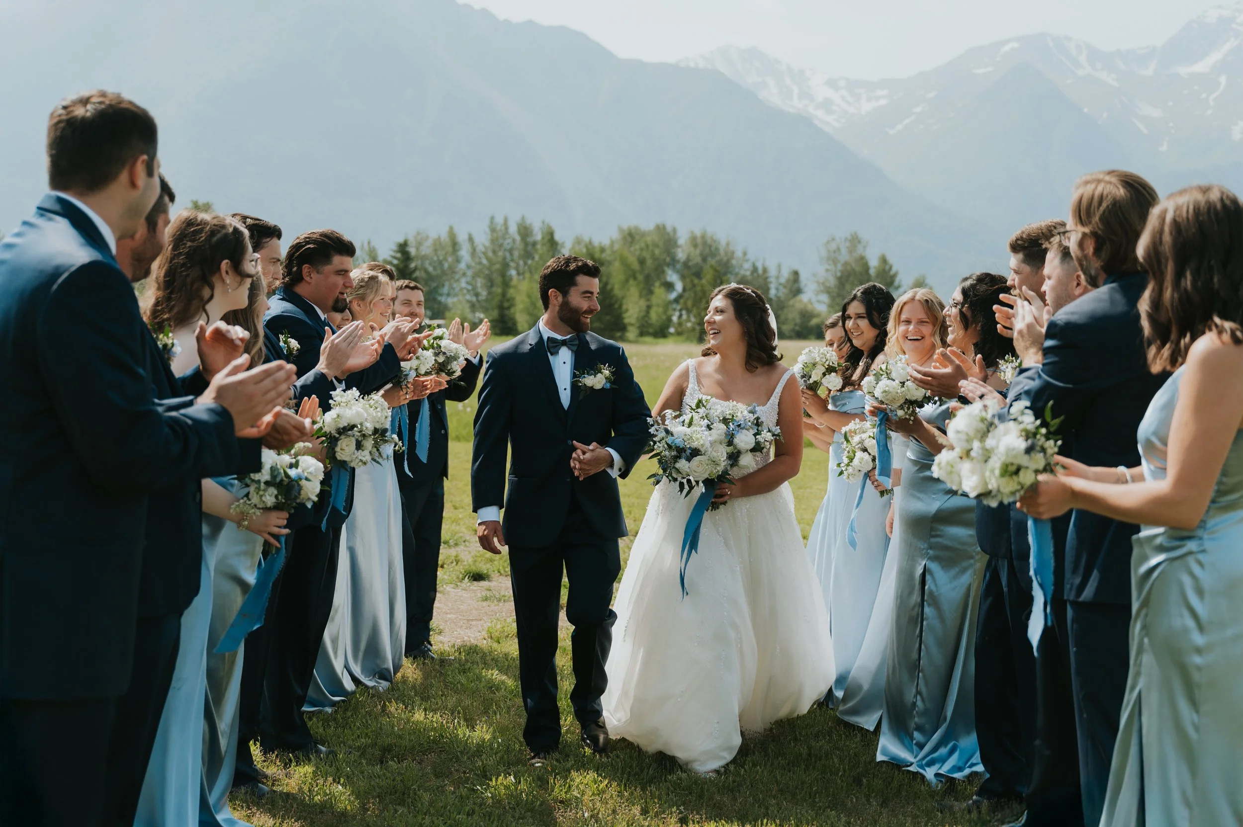 bride and groom surrounded by wedding party