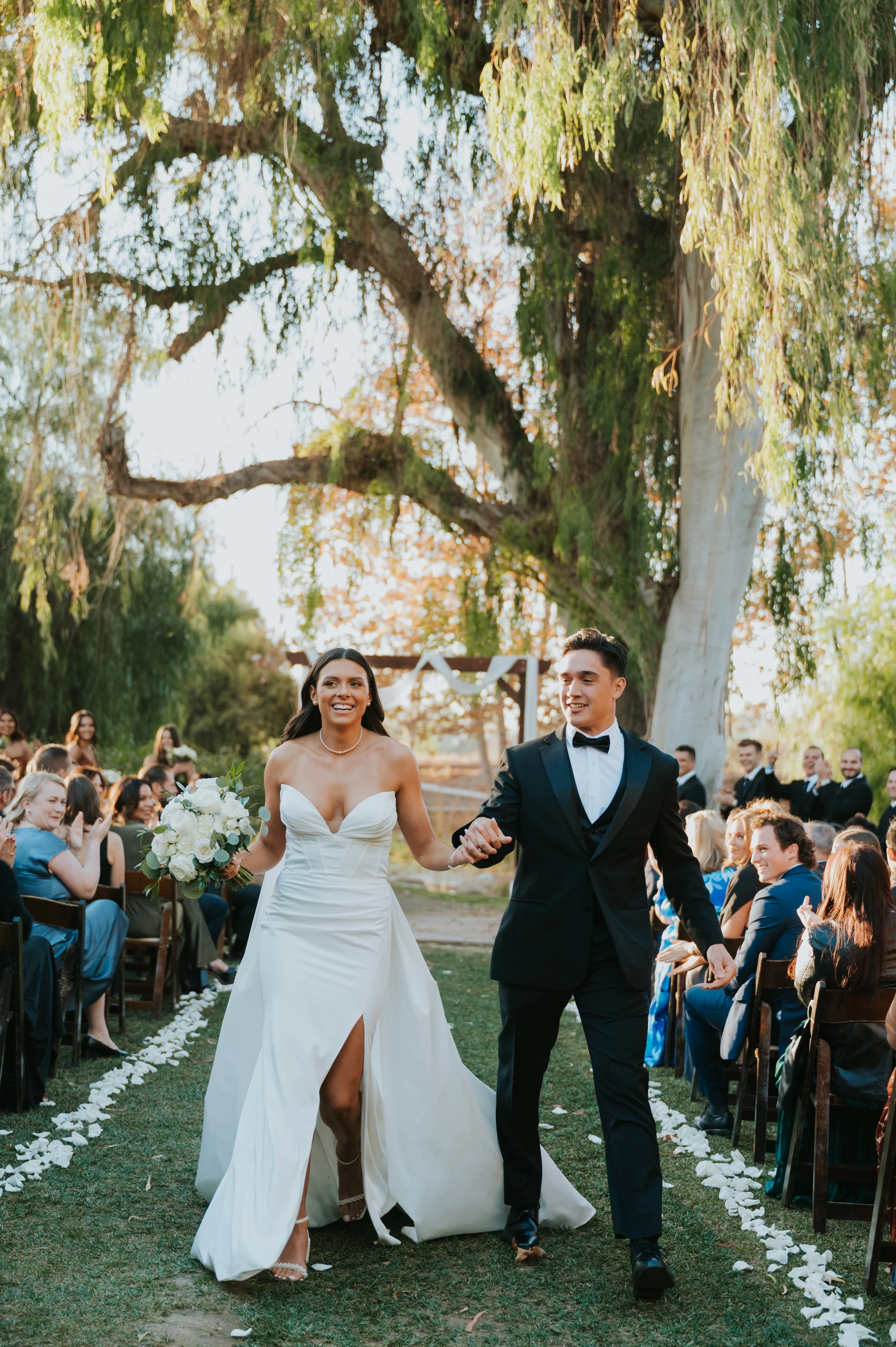 newly married couple walking down aisle