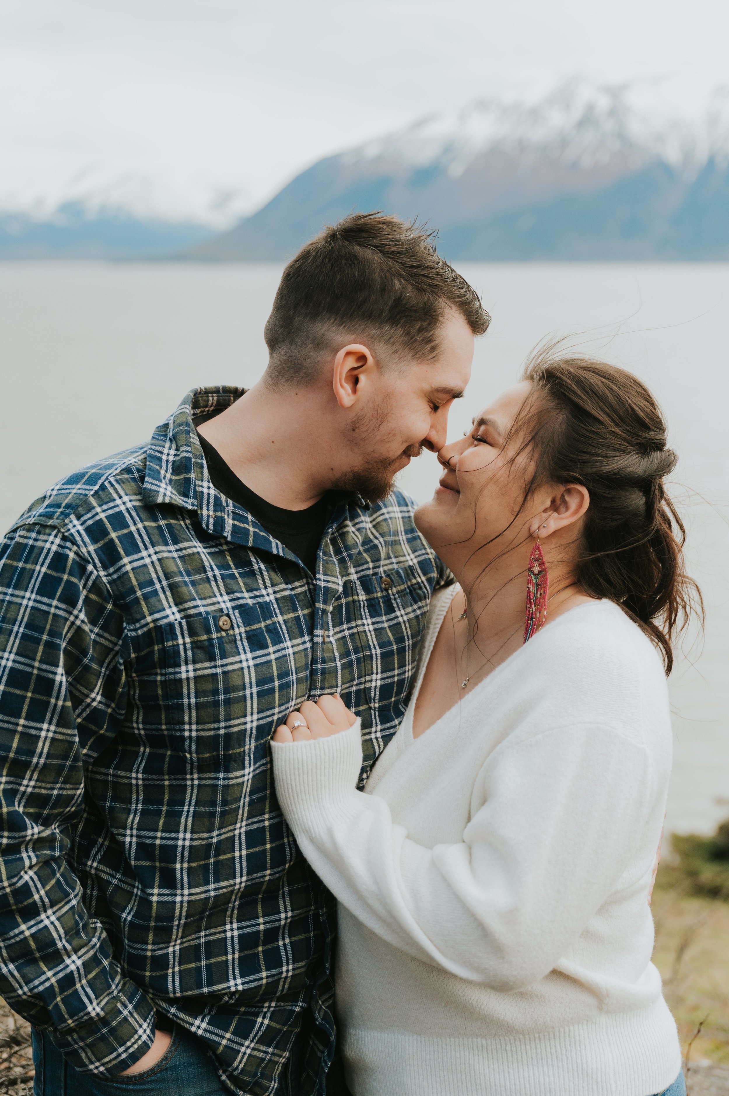 engaged couple smiling at each other touching noses