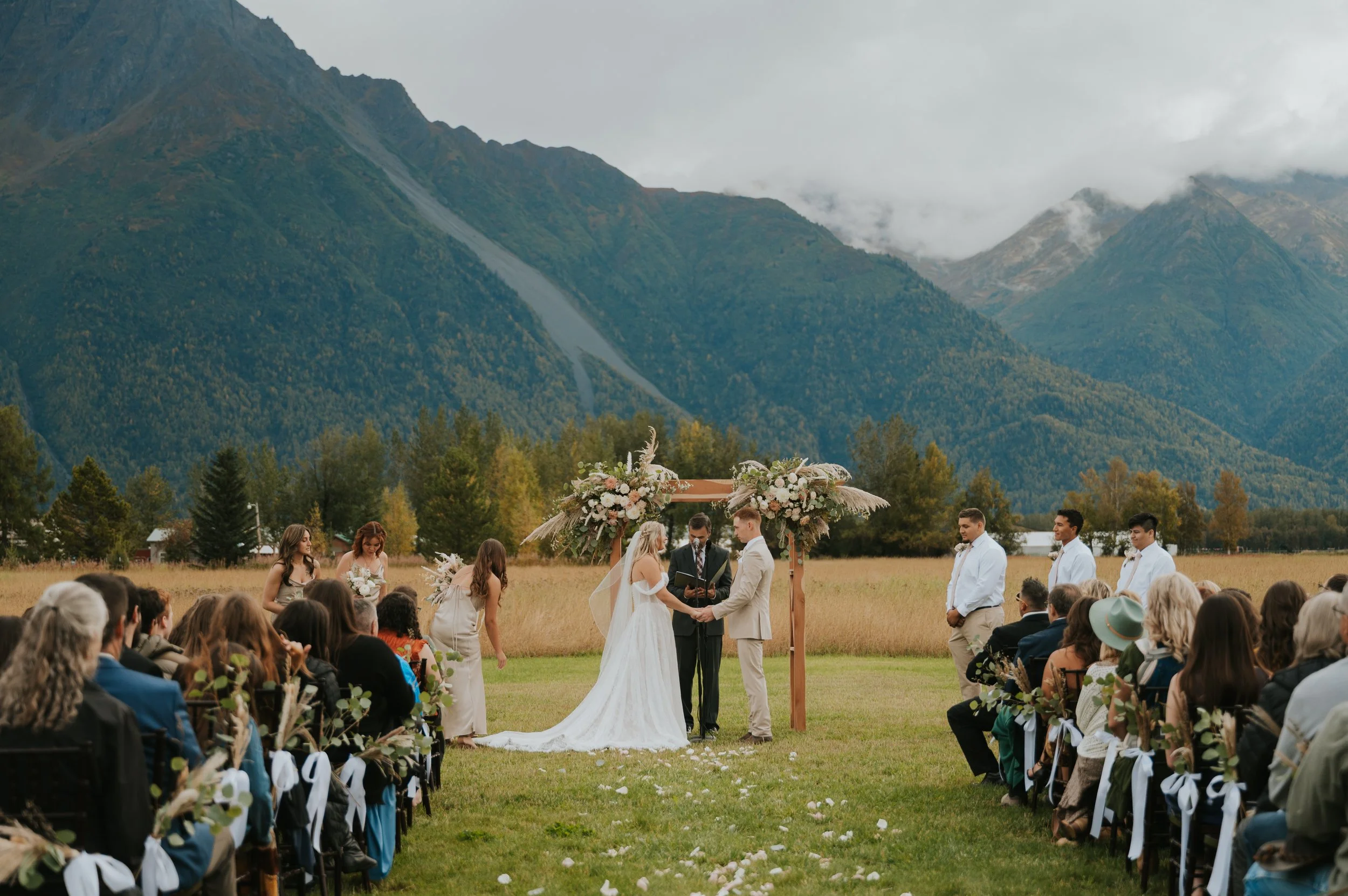 bride and groom holding hands at altar