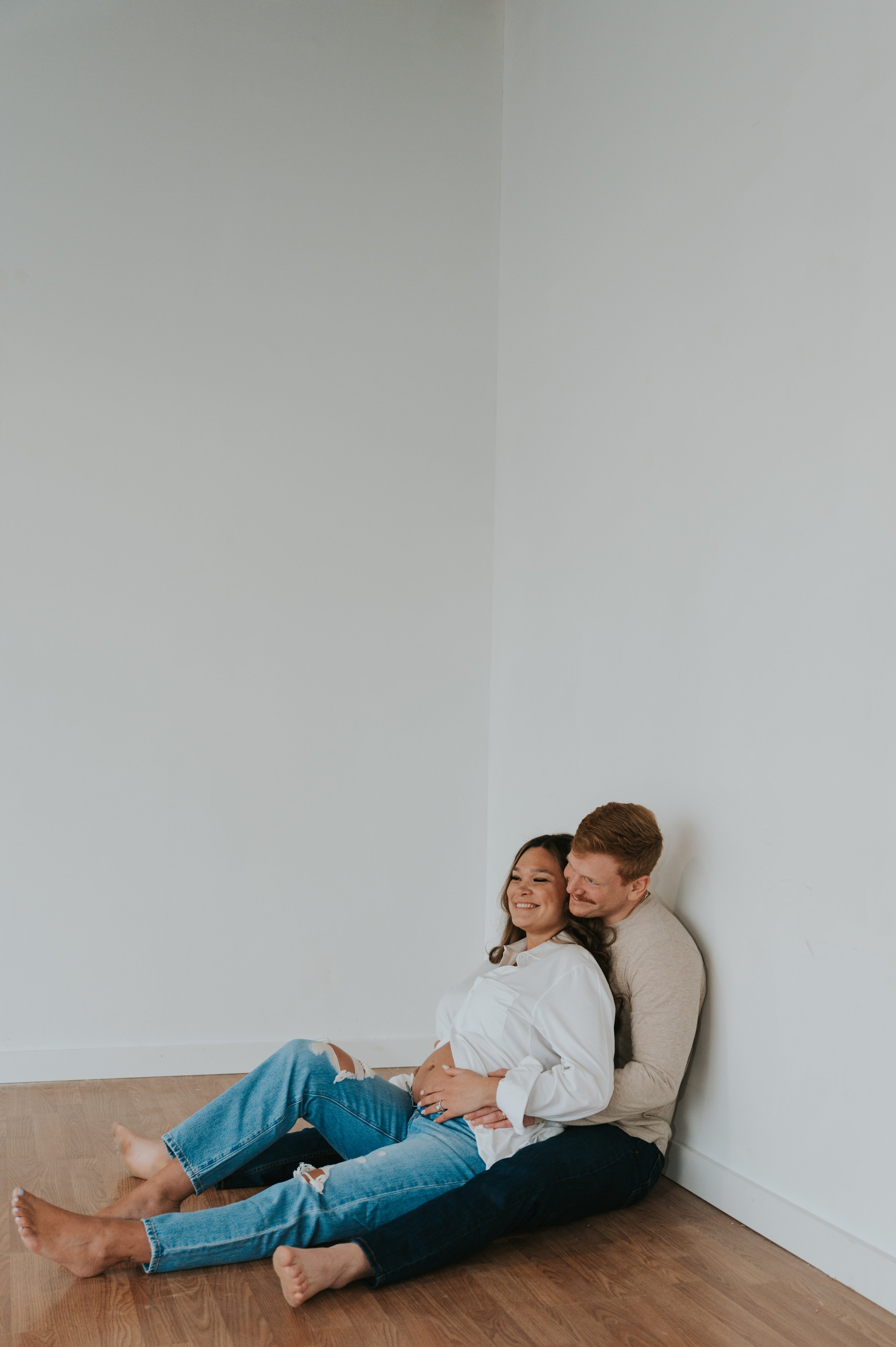 couple in white studio maternity photos