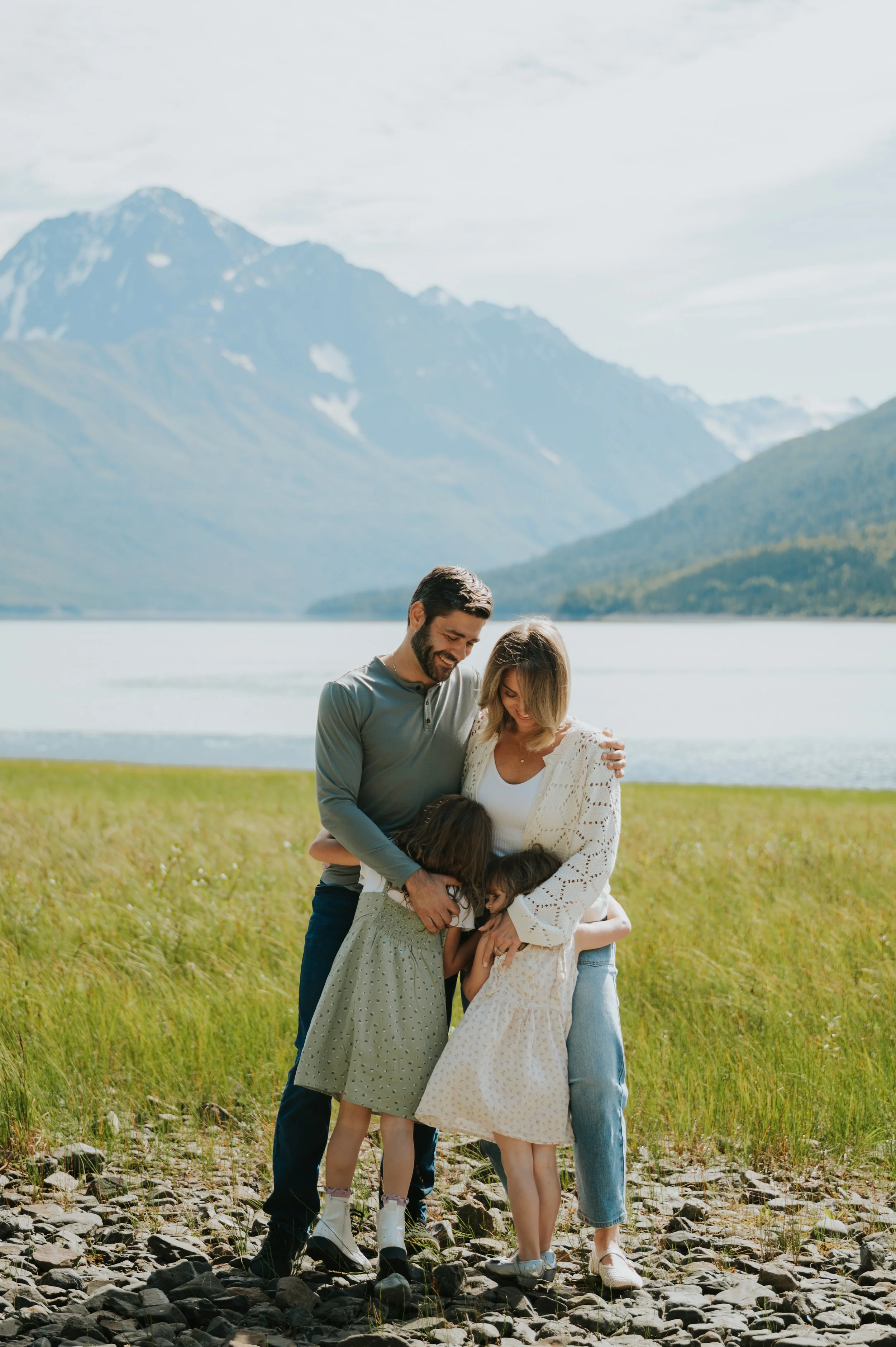 family hug at alpine lake